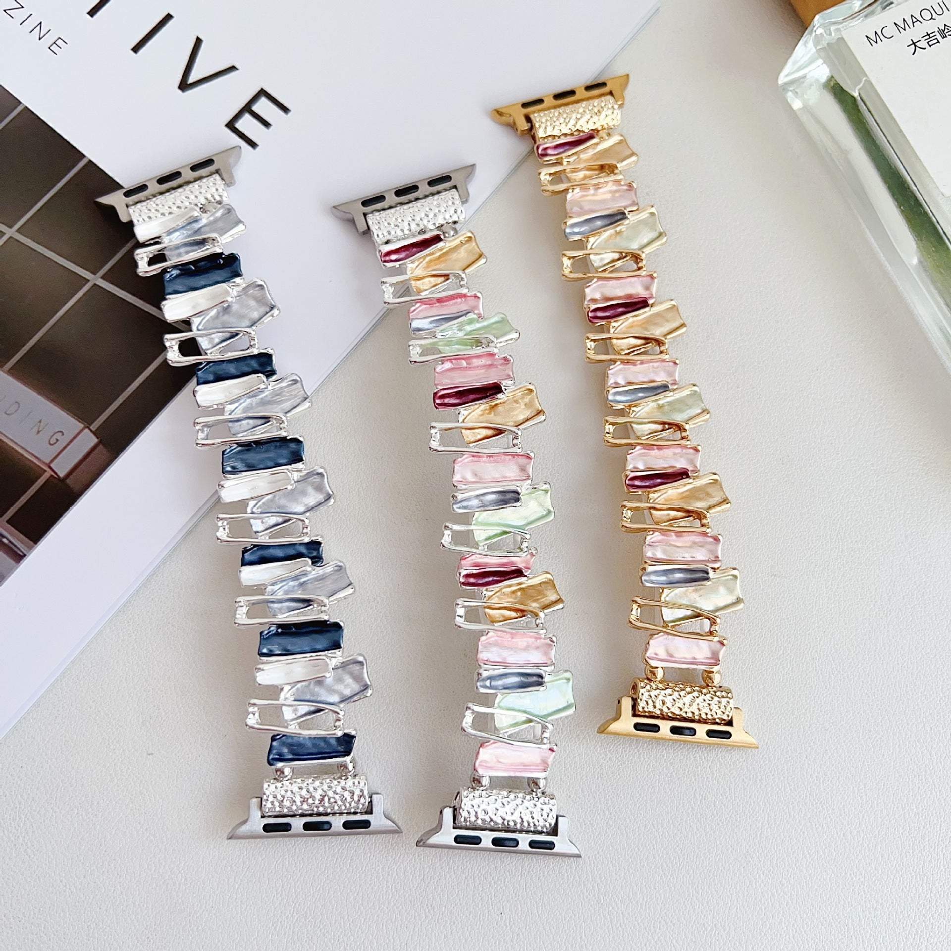 Dopamine oil painting metal stretch watch bands in blue silver, multicolor silver, and multicolor gold for Apple watches.