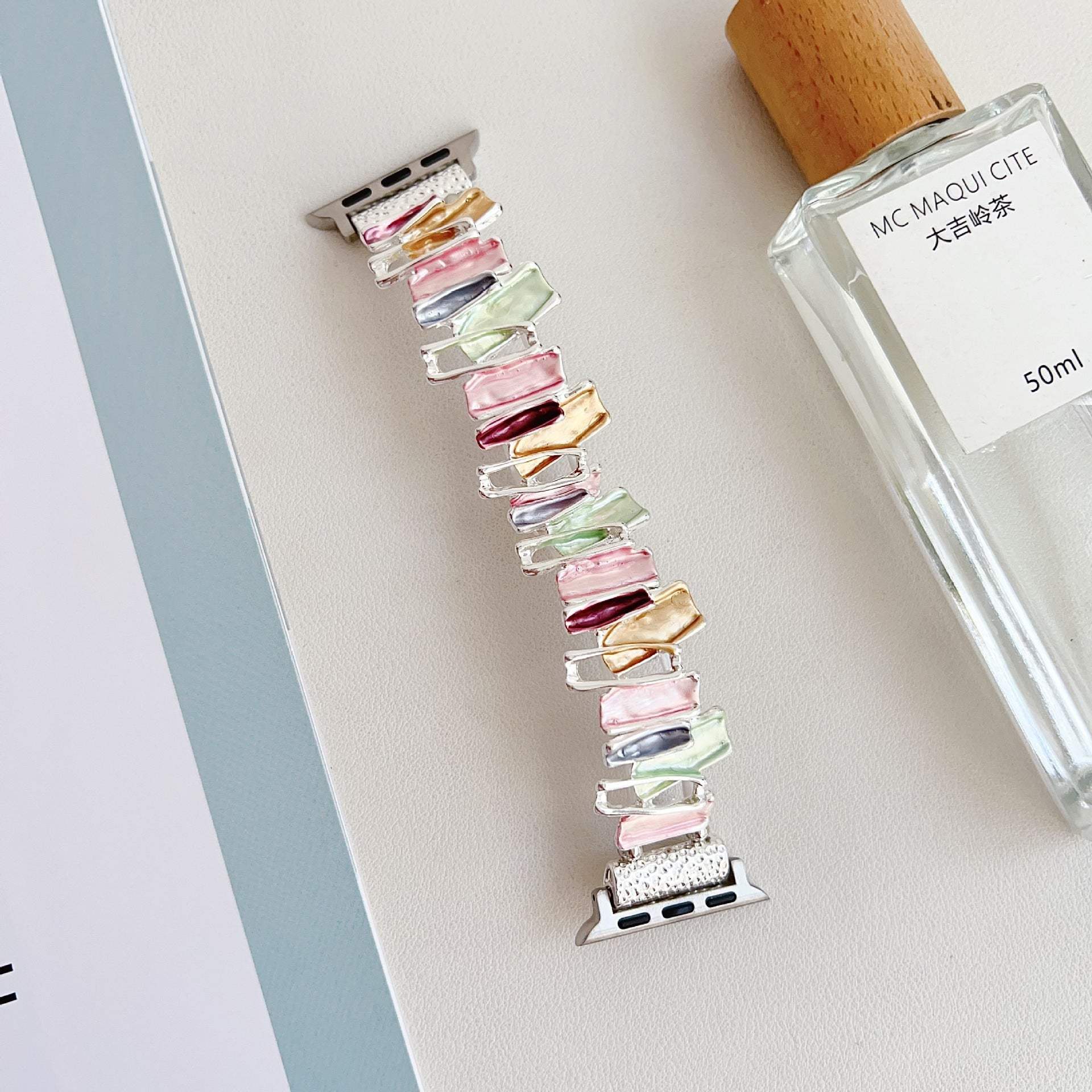 Dopamine oil painting metal stretch watch band with colorful glossy rectangular links designed for Apple watches.