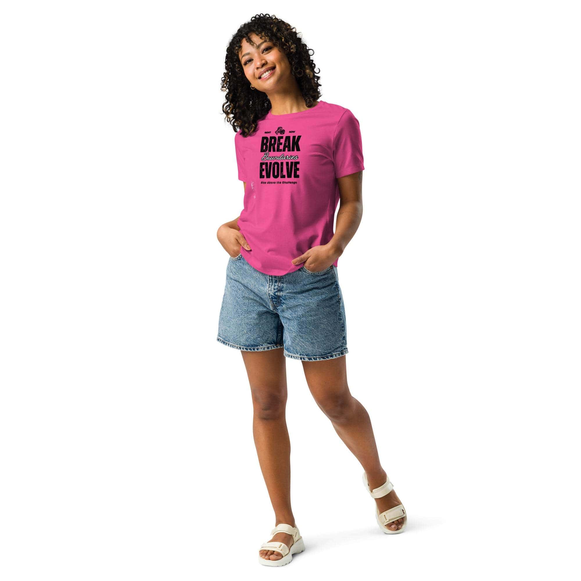 Woman wearing pink Break Boundaries Evolve T-Shirt with motivational quote and denim shorts