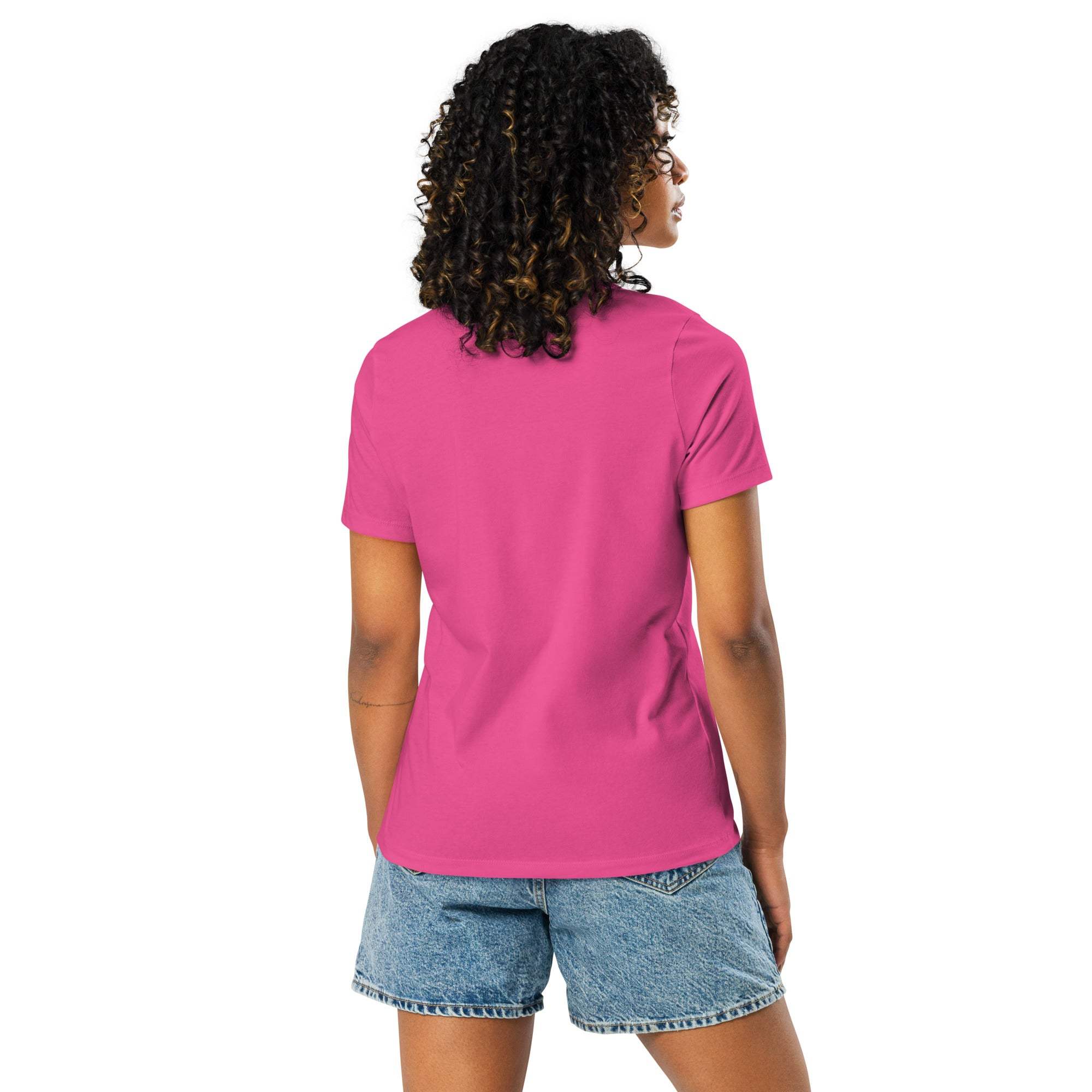Woman wearing bright pink Break Boundaries Evolve T-Shirt with short sleeves and blue denim shorts, back view.