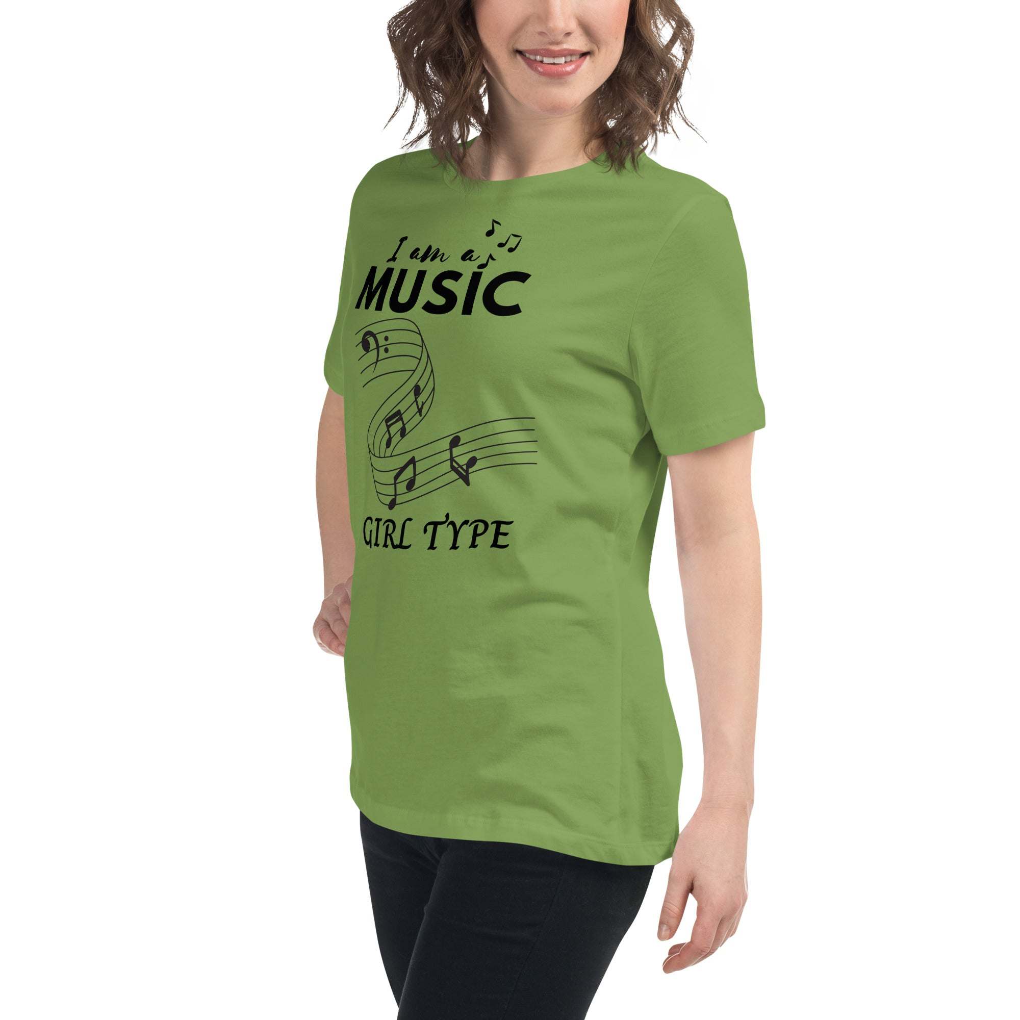 Green Music Girl T-Shirt with playful musical notes graphic worn by smiling woman in casual black pants