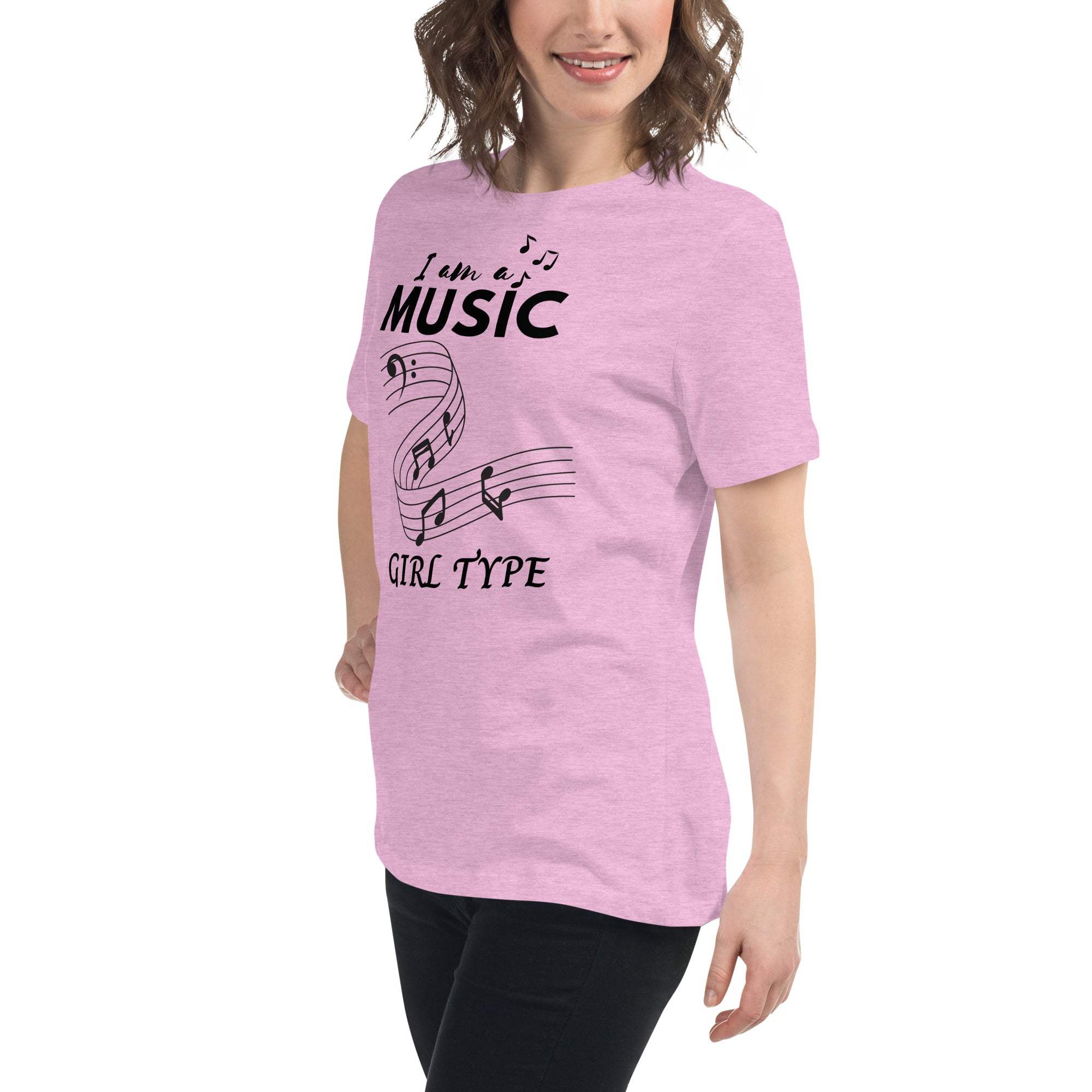 Woman wearing a pink Music Girl T-Shirt with black musical notes graphic and text, paired with black pants.