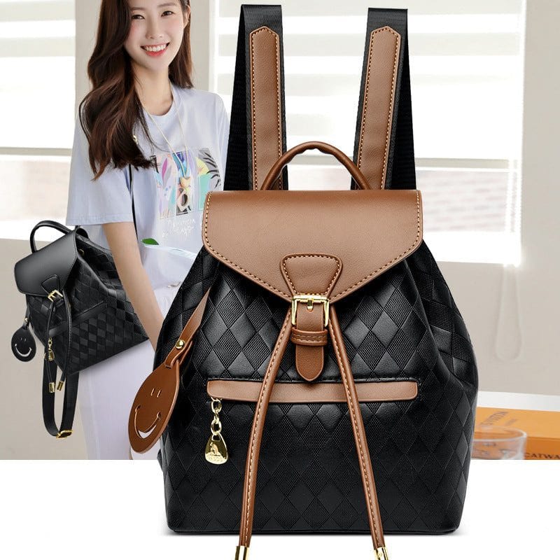 Stylish multifunction black and brown leather female backpack with quilted pattern and buckle closure worn by woman