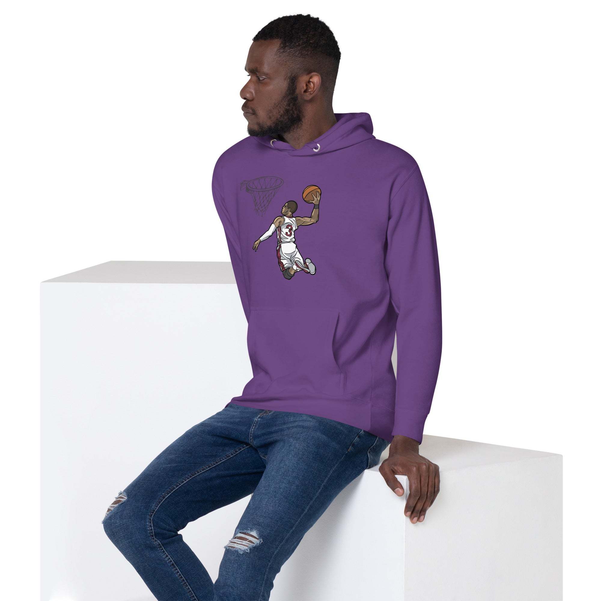 Man wearing purple Basketball Dunk Hoodie with slam dunk graphic sitting on white block