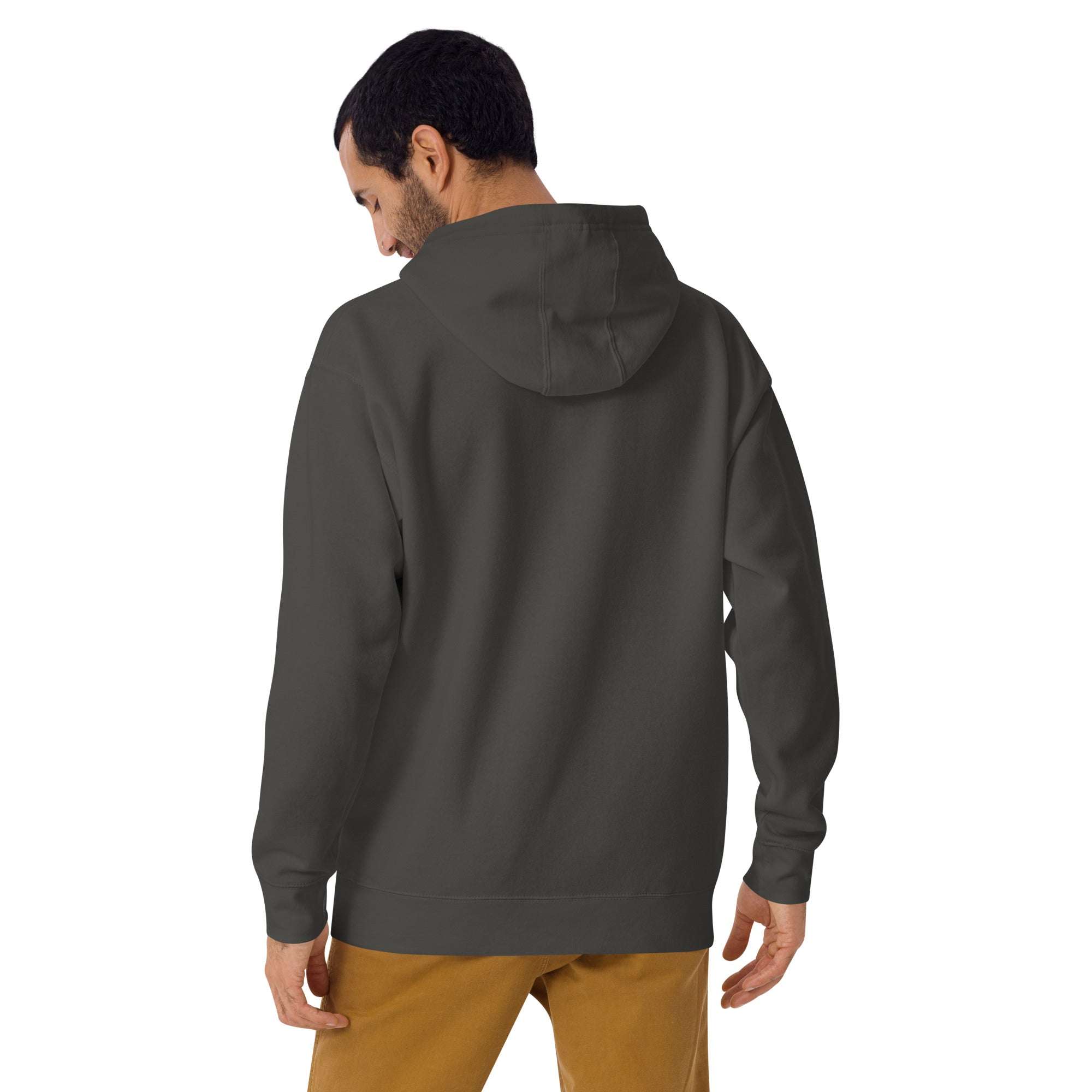Back view of a man wearing a dark green Wander Without Limits Hoodie, showcasing the hood and comfortable fit.