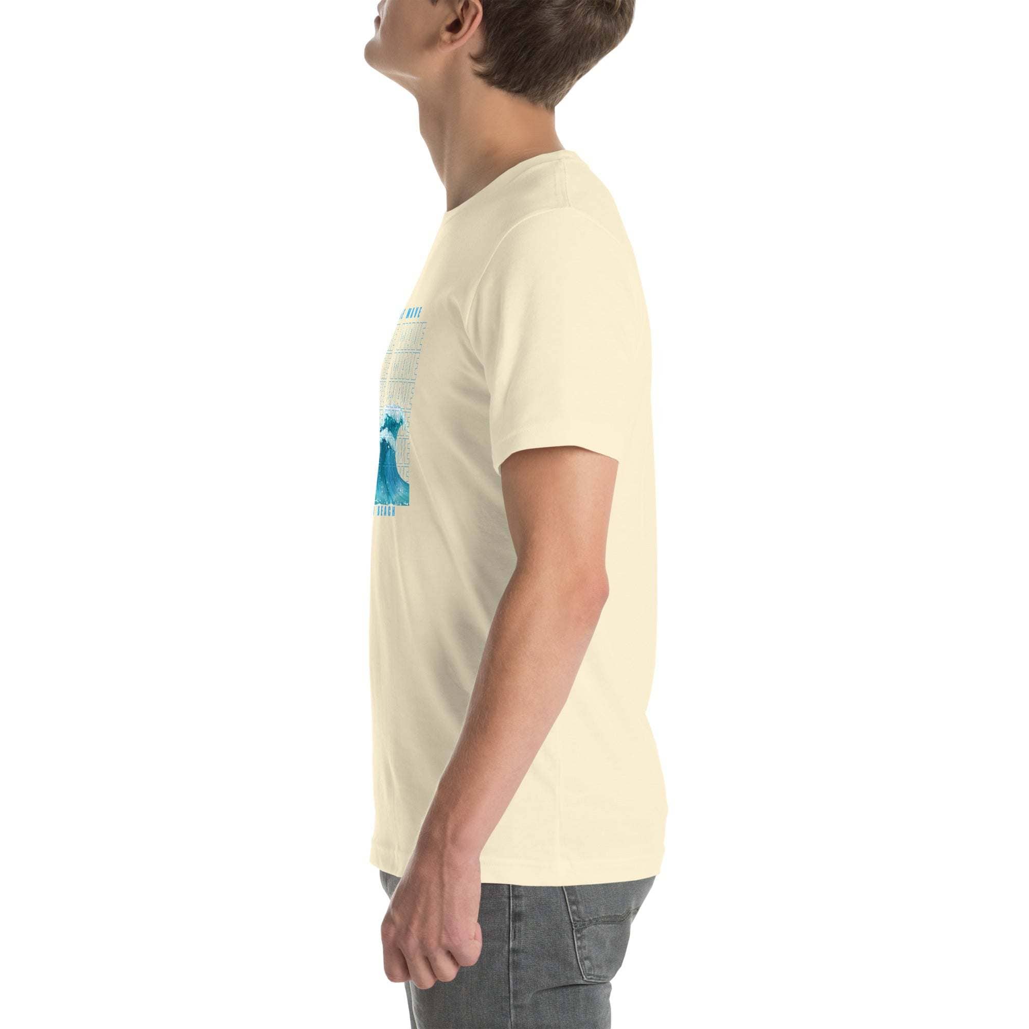 Side view of man wearing beige Ride the Wave T-Shirt with blue wave design and casual jeans