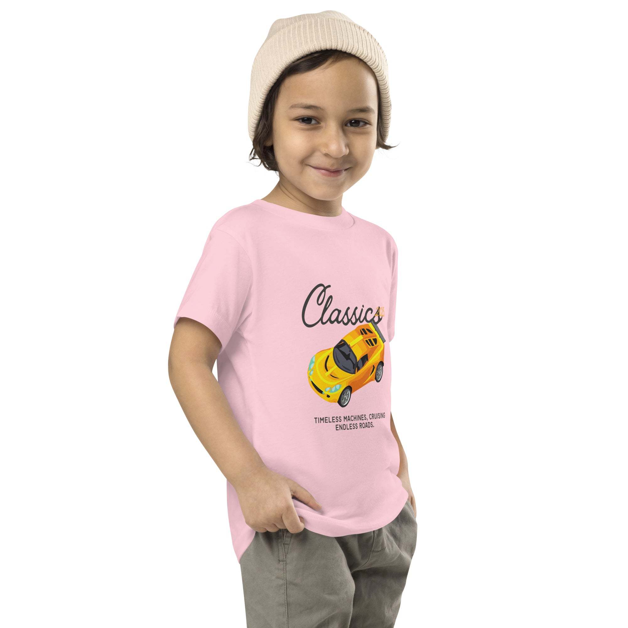 Child wearing pink Classic Car Kids T-Shirt with yellow vintage sports car design and beige hat