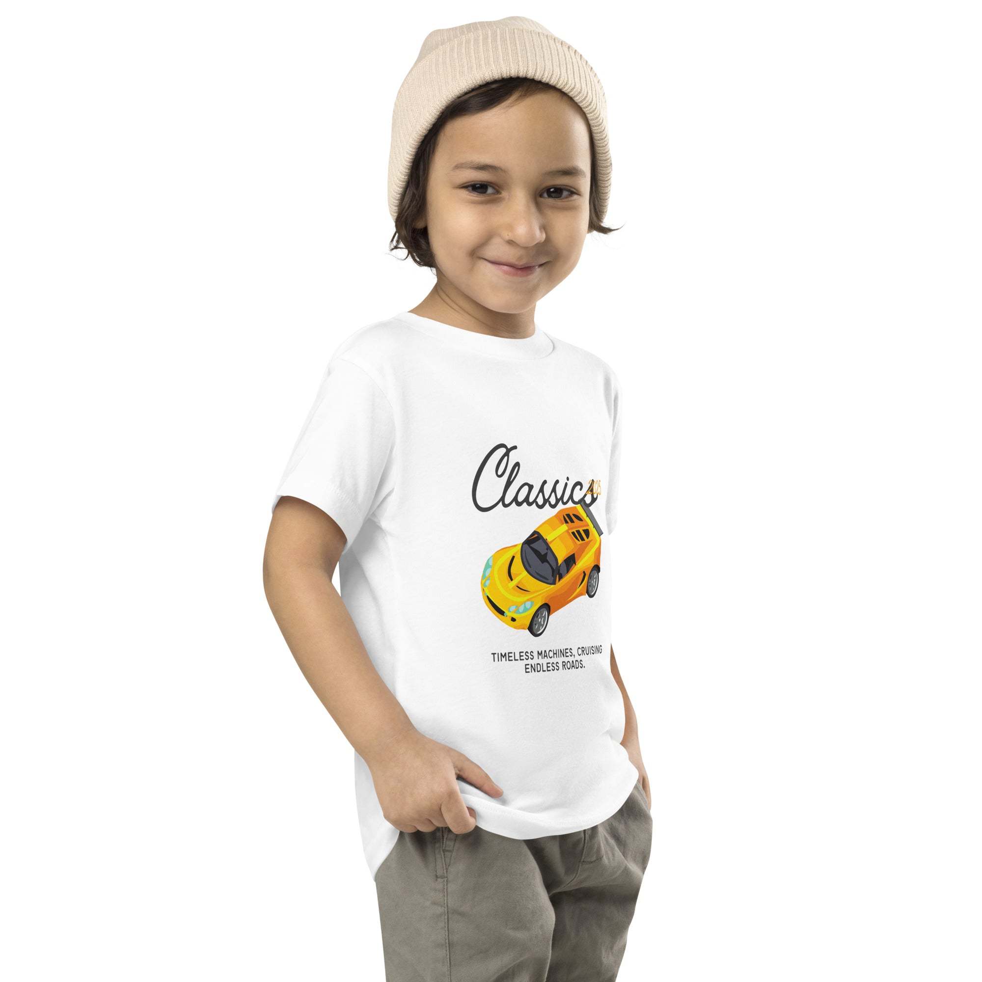 Toddler wearing white Classic Car Kids T-Shirt with yellow vintage sports car design and beanie hat