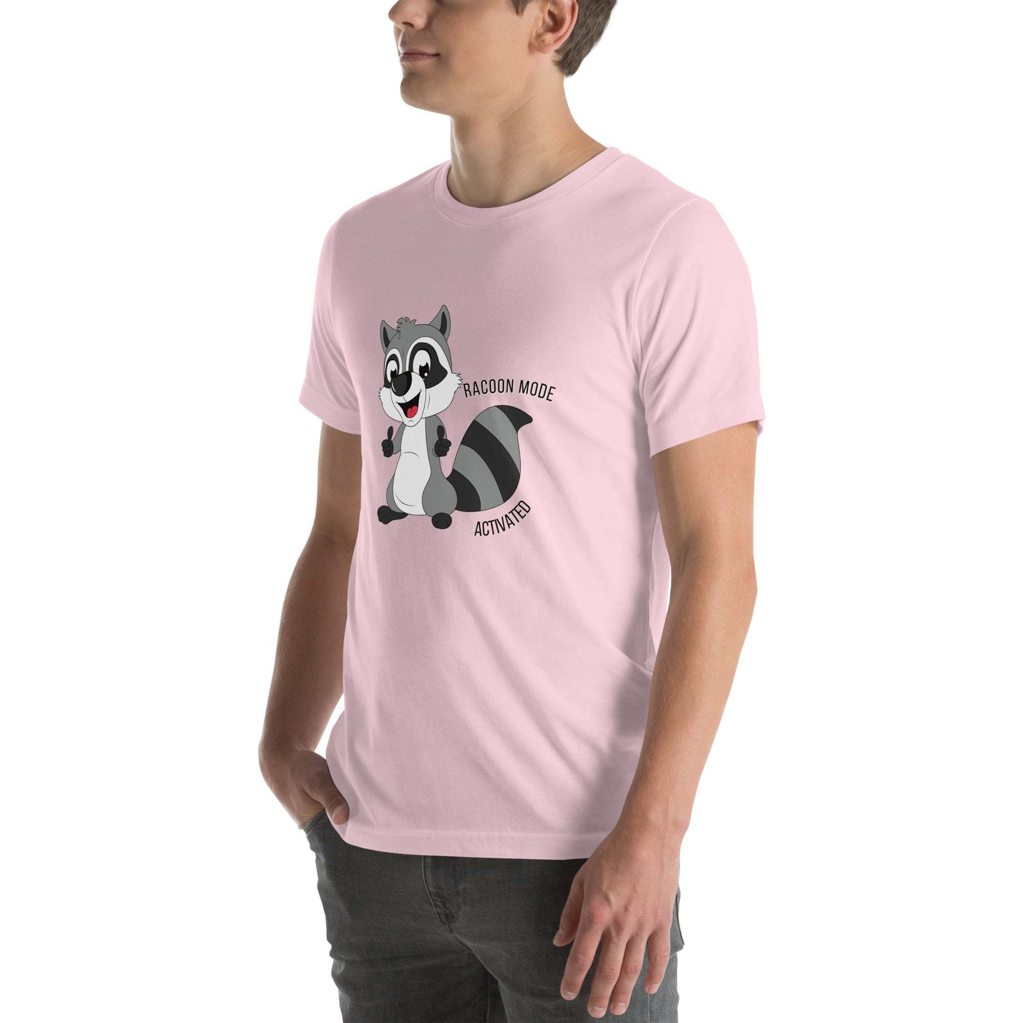 Man wearing light pink Raccoon Mode T-Shirt with cartoon raccoon and "Raccoon Mode Activated" text