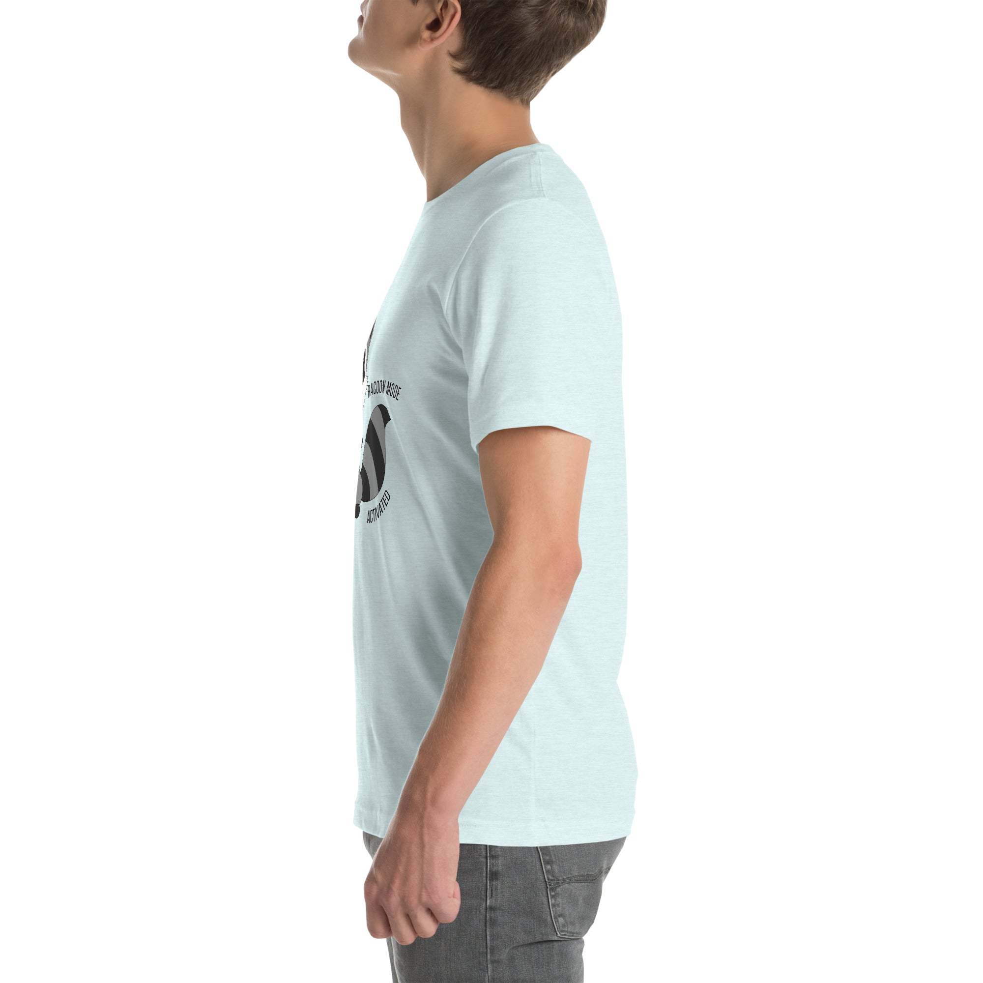 Side view of a man wearing a light blue Raccoon Mode T-Shirt with cartoon raccoon and "Raccoon Mode Activated" text