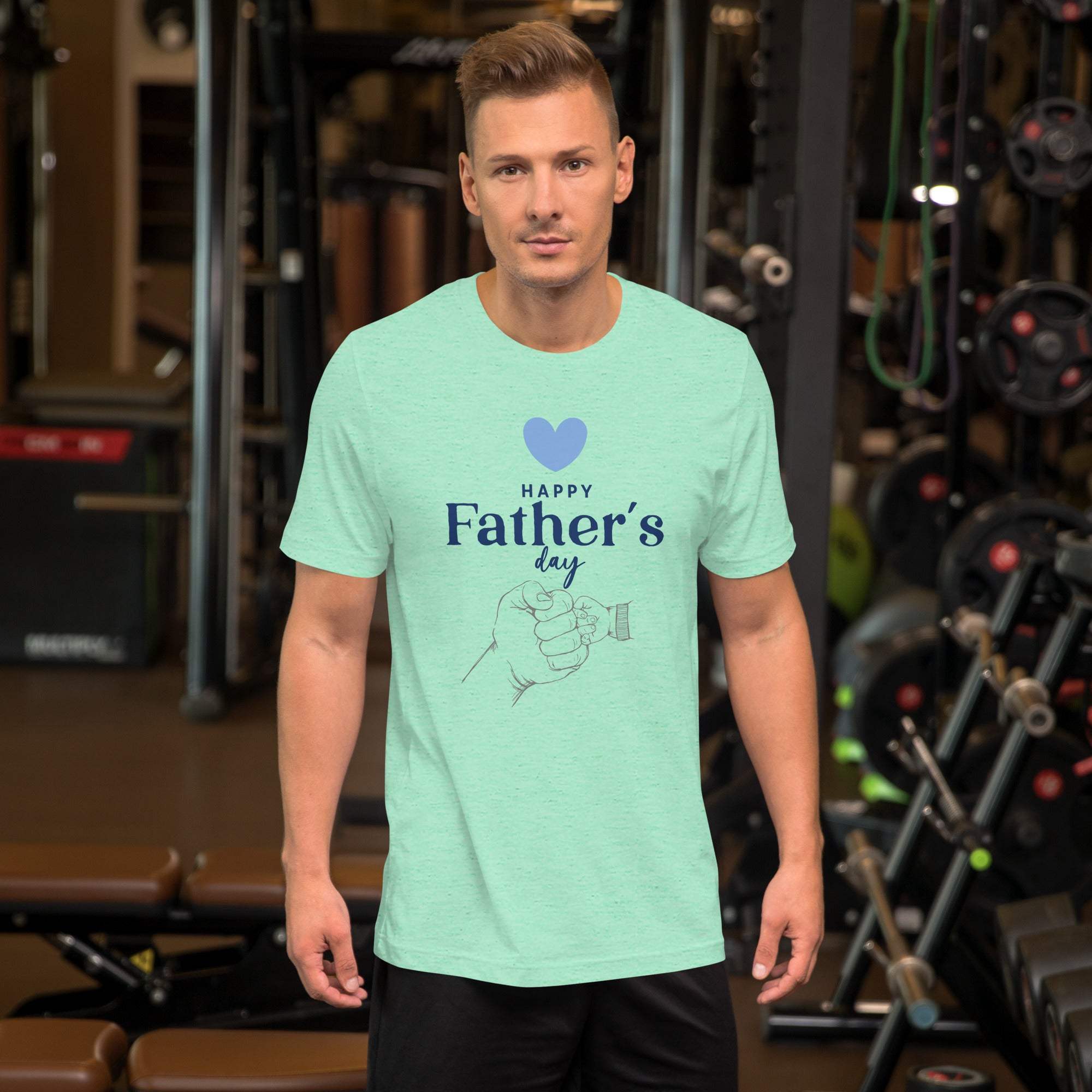 Man wearing light green Father's Day T-Shirt with heart and hand design in gym setting
