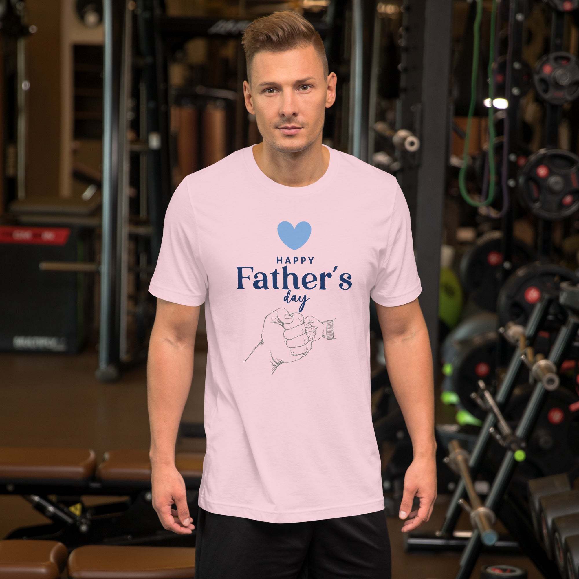 Man wearing pink Happy Father's Day T-shirt with heart and hand design in gym