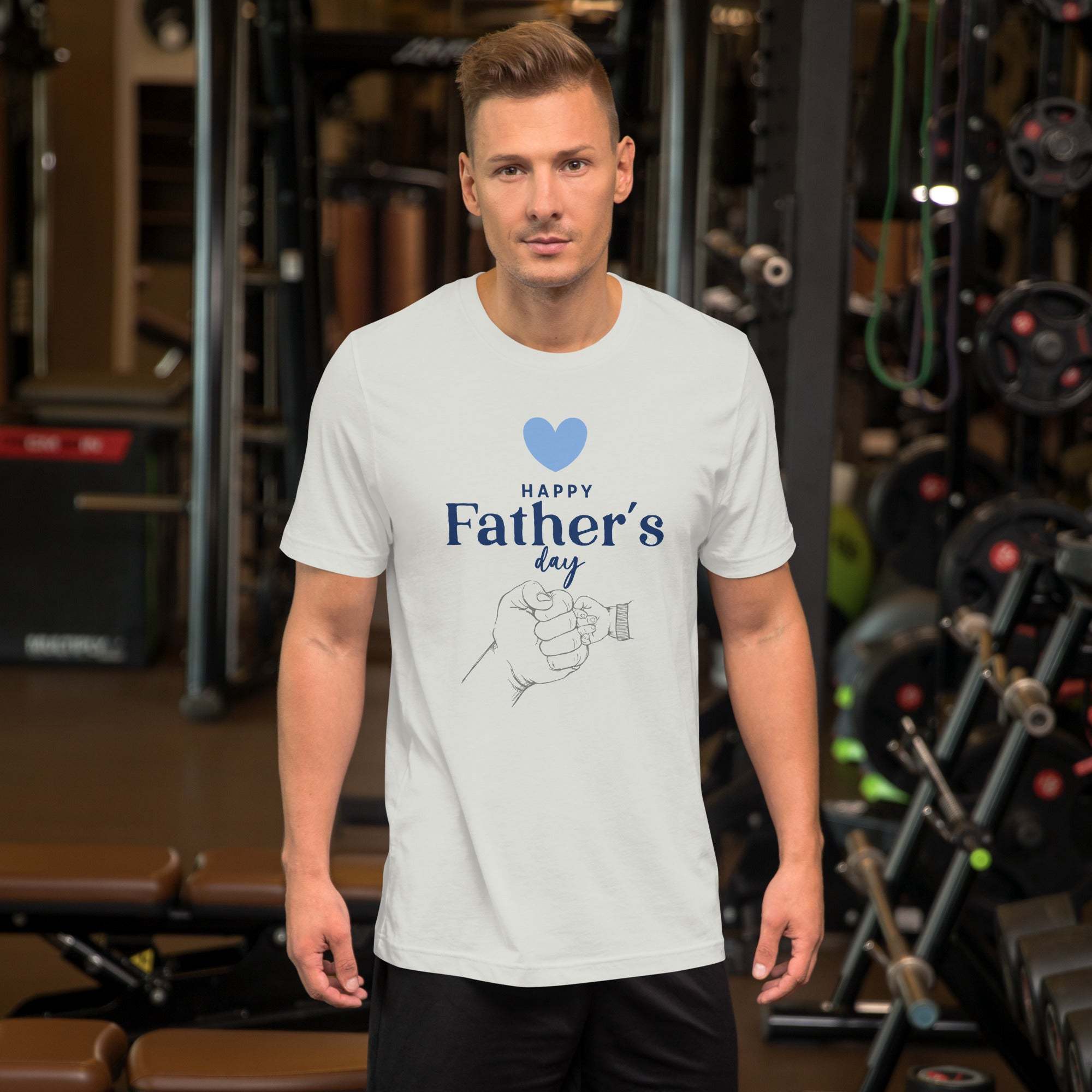 Man wearing white Father's Day T-Shirt with heart and hand design in gym setting