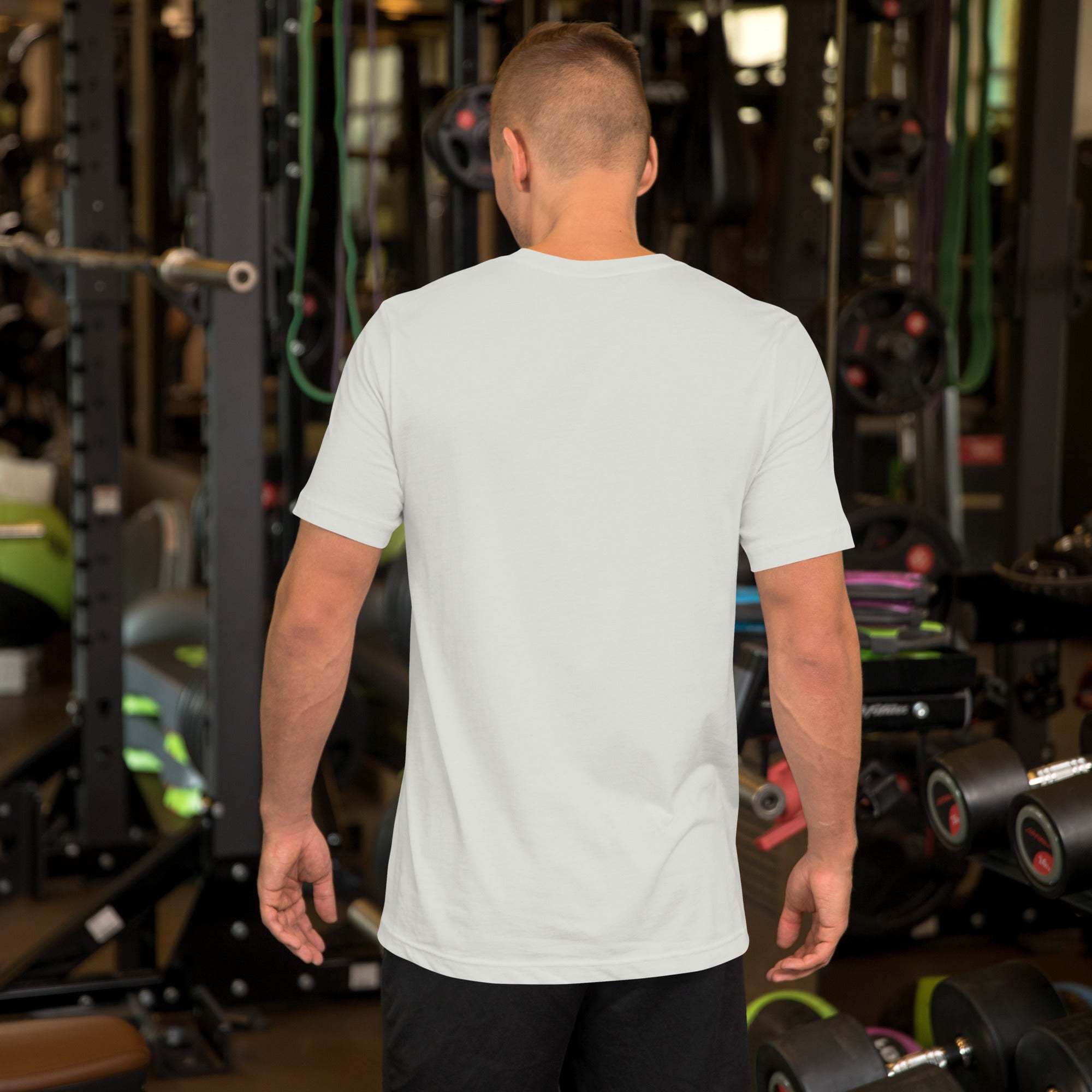 Man wearing plain white Father's Day T-Shirt with heart and hand design in gym setting