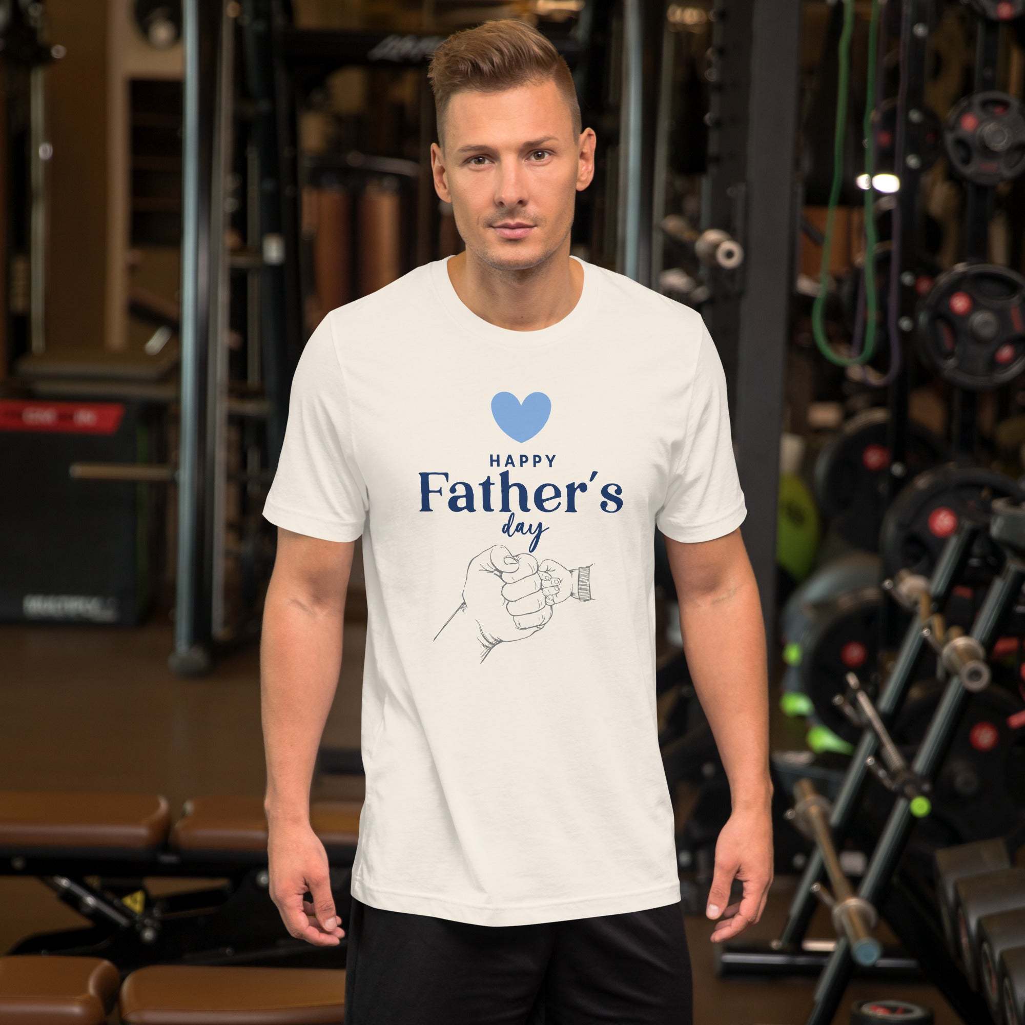 Man wearing white Father's Day T-Shirt with heart and hand design in gym setting