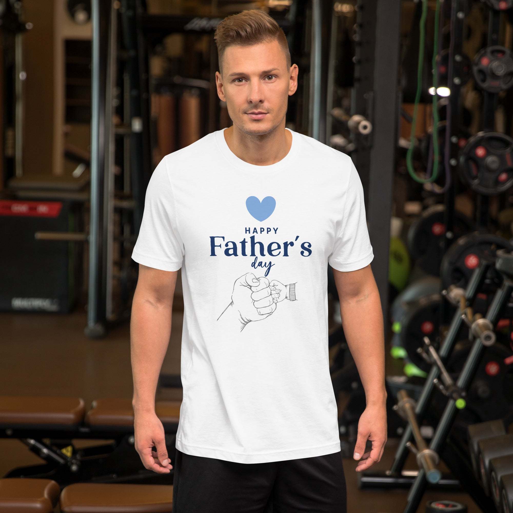 Man wearing white Father's Day T-Shirt with heart and hand design in gym setting