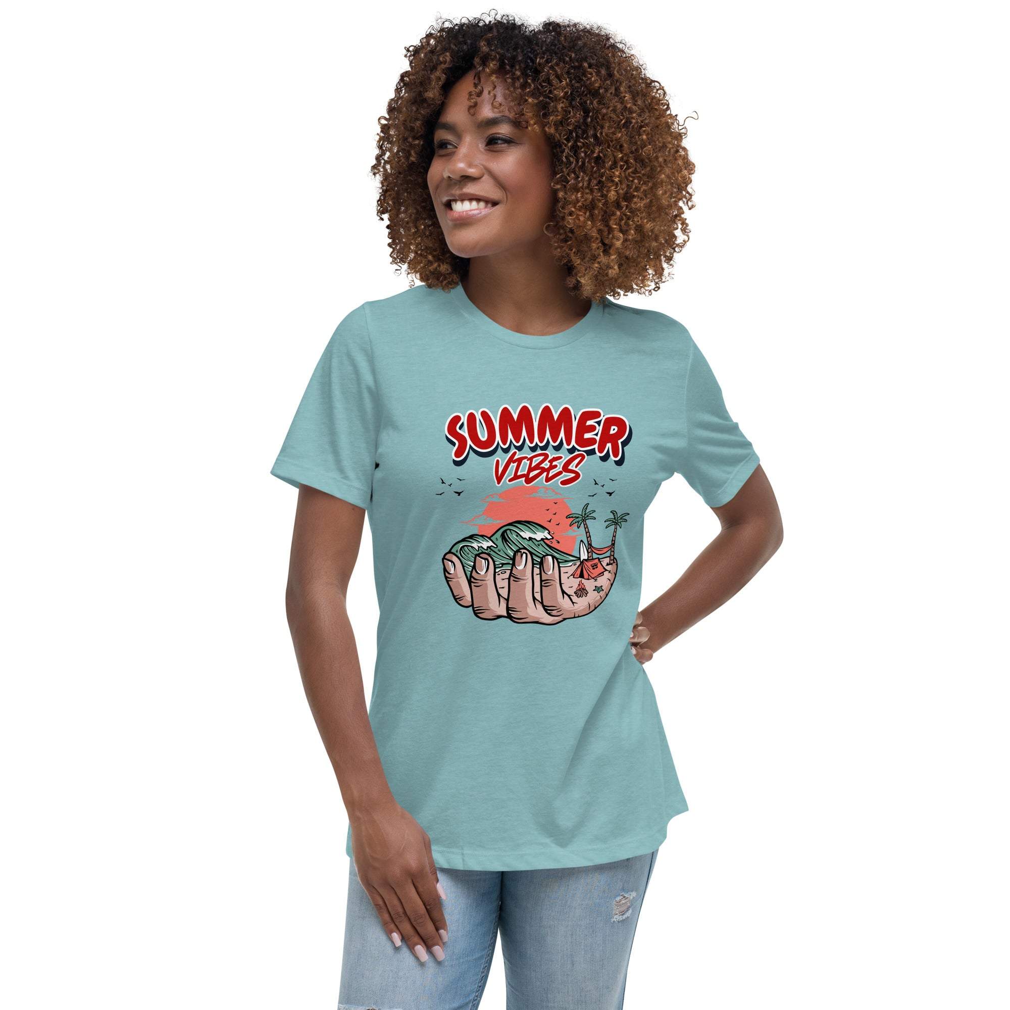 Woman wearing light blue Summer Vibes T-Shirt with retro beach graphic held in a hand, paired with ripped jeans