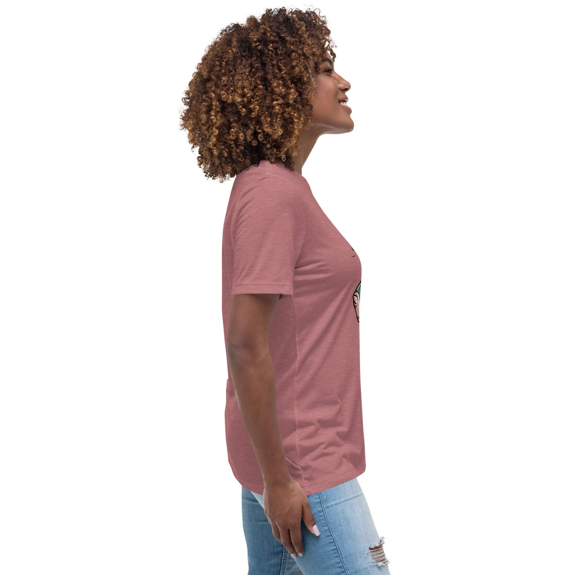 Side view of woman wearing pink Summer Vibes T-Shirt with retro beach graphic and light blue jeans