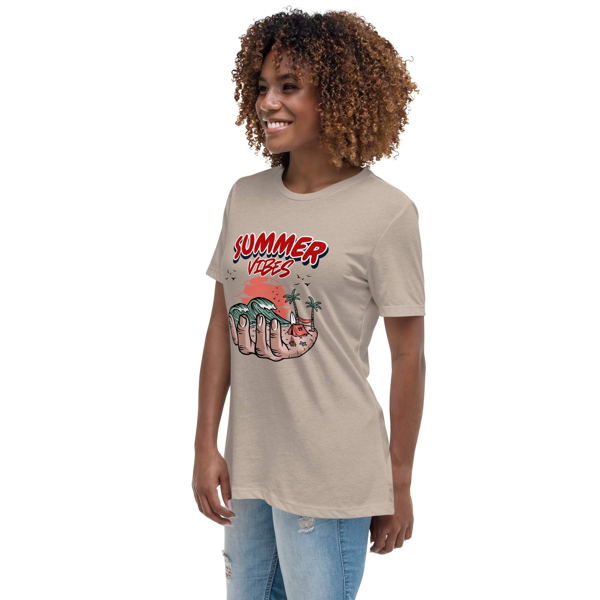 Woman wearing beige Summer Vibes T-Shirt with retro beach graphic featuring a hand holding waves and palm trees.