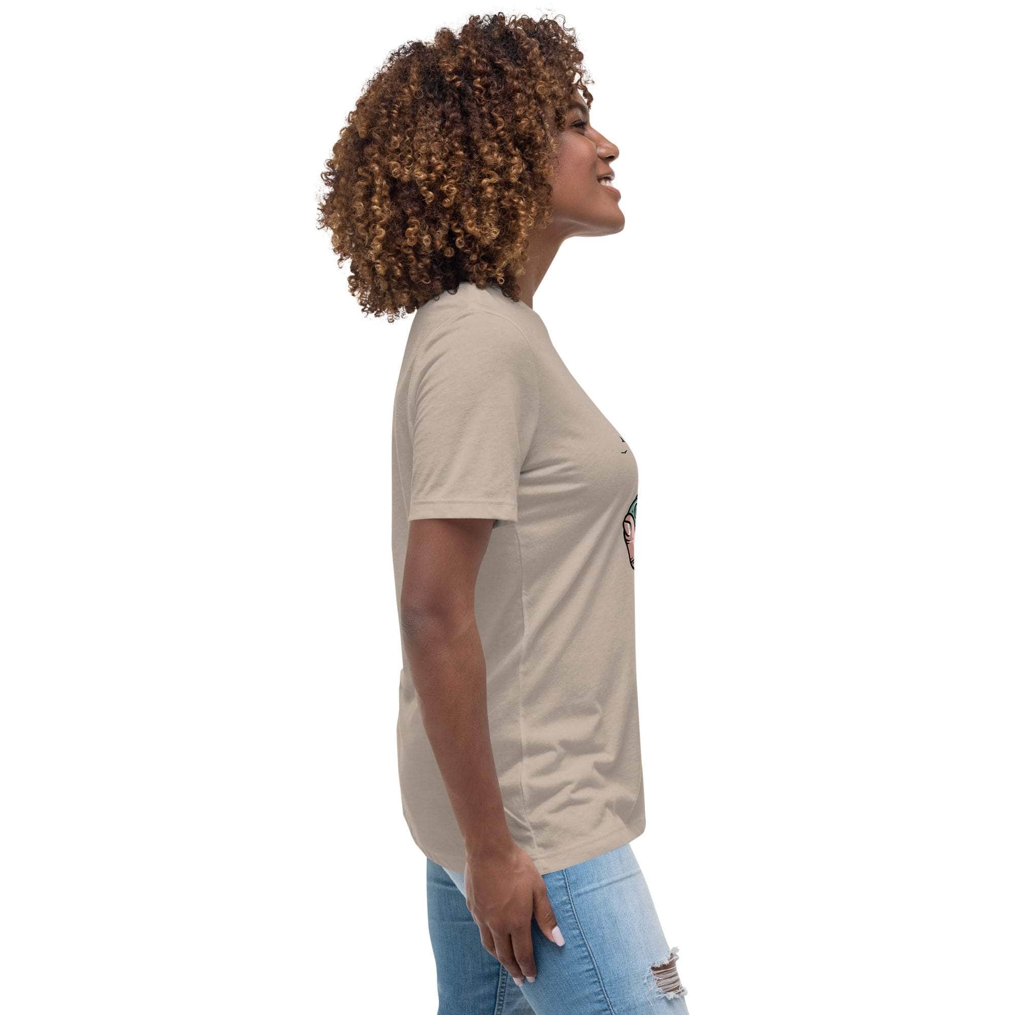 Side view of woman wearing beige Summer Vibes T-Shirt with retro beach graphic and light blue ripped jeans
