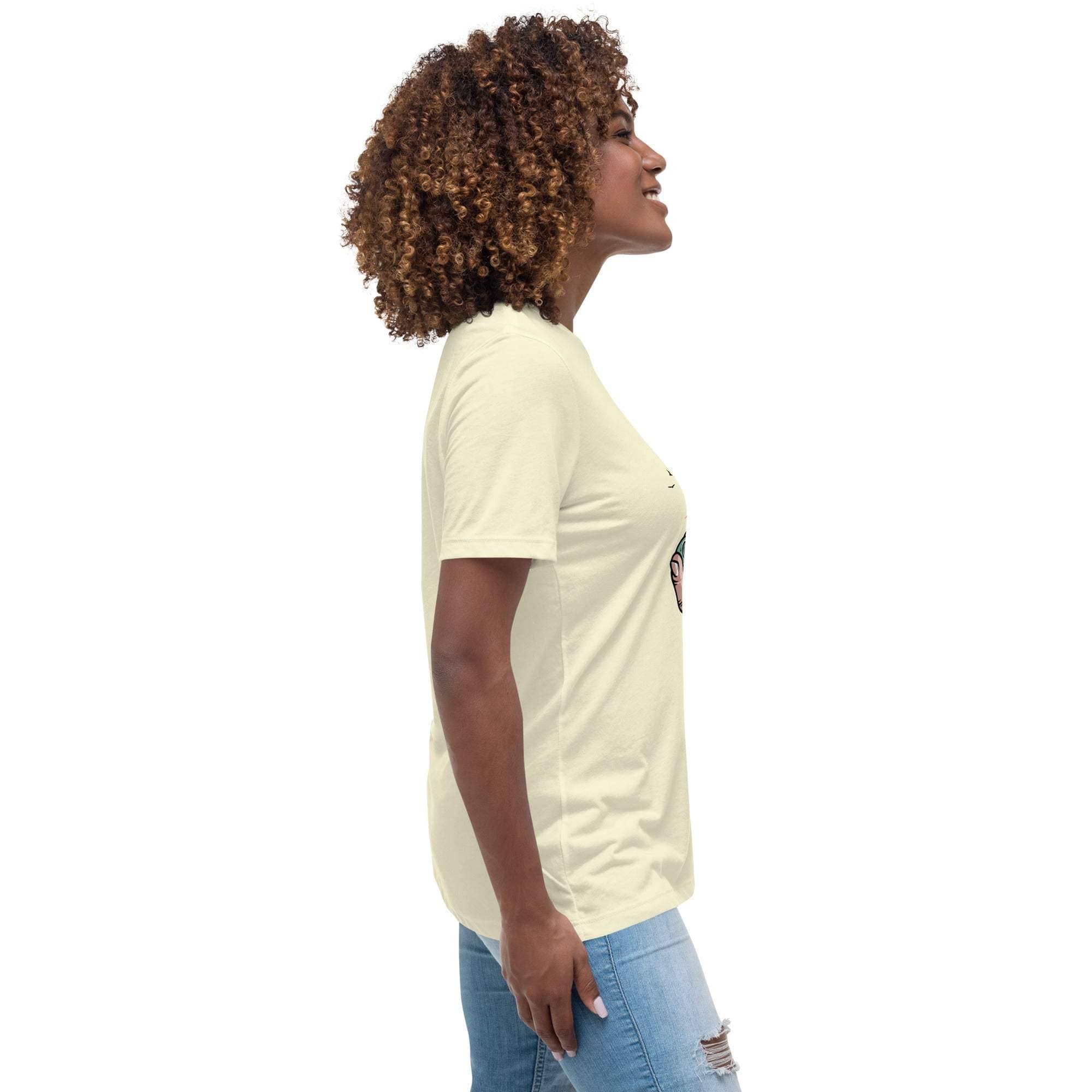 Woman wearing light yellow Summer Vibes T-Shirt with retro beach graphic on side, paired with ripped blue jeans