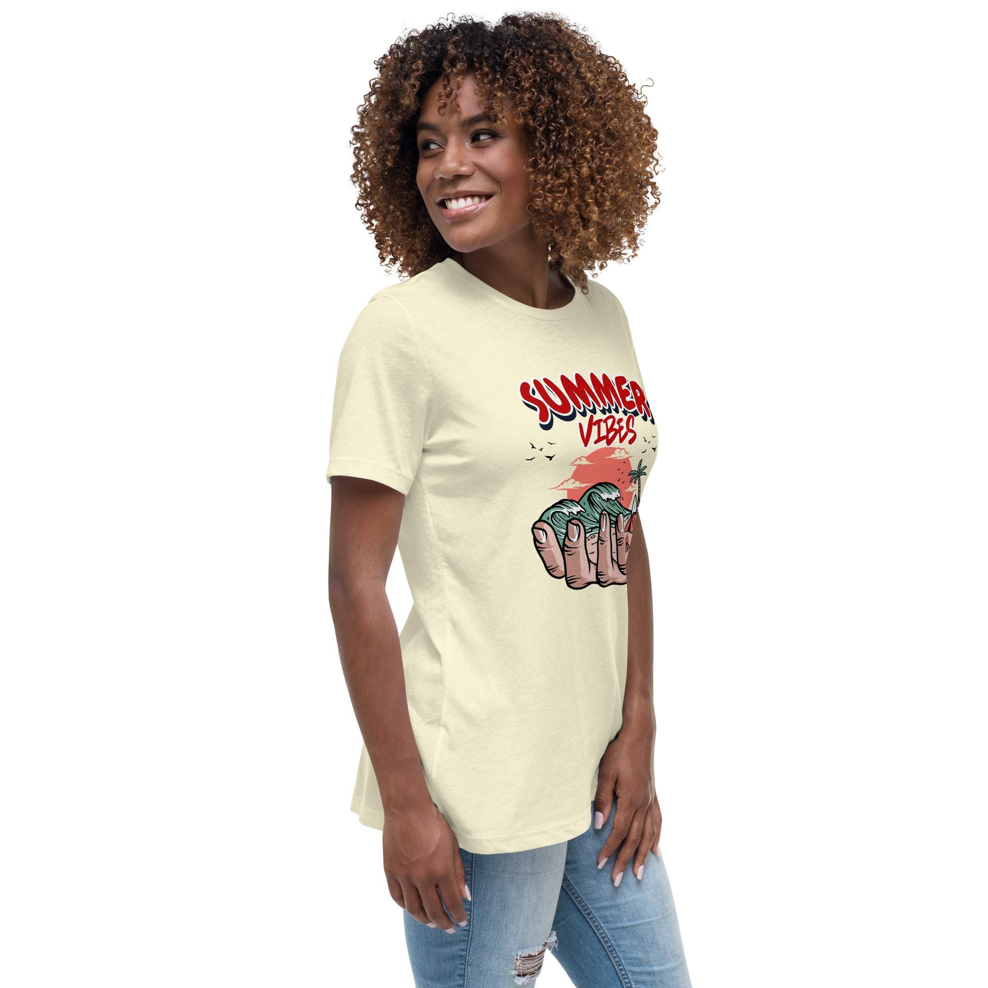 Woman wearing a cream Summer Vibes T-Shirt with retro beach graphic and text, paired with ripped jeans.