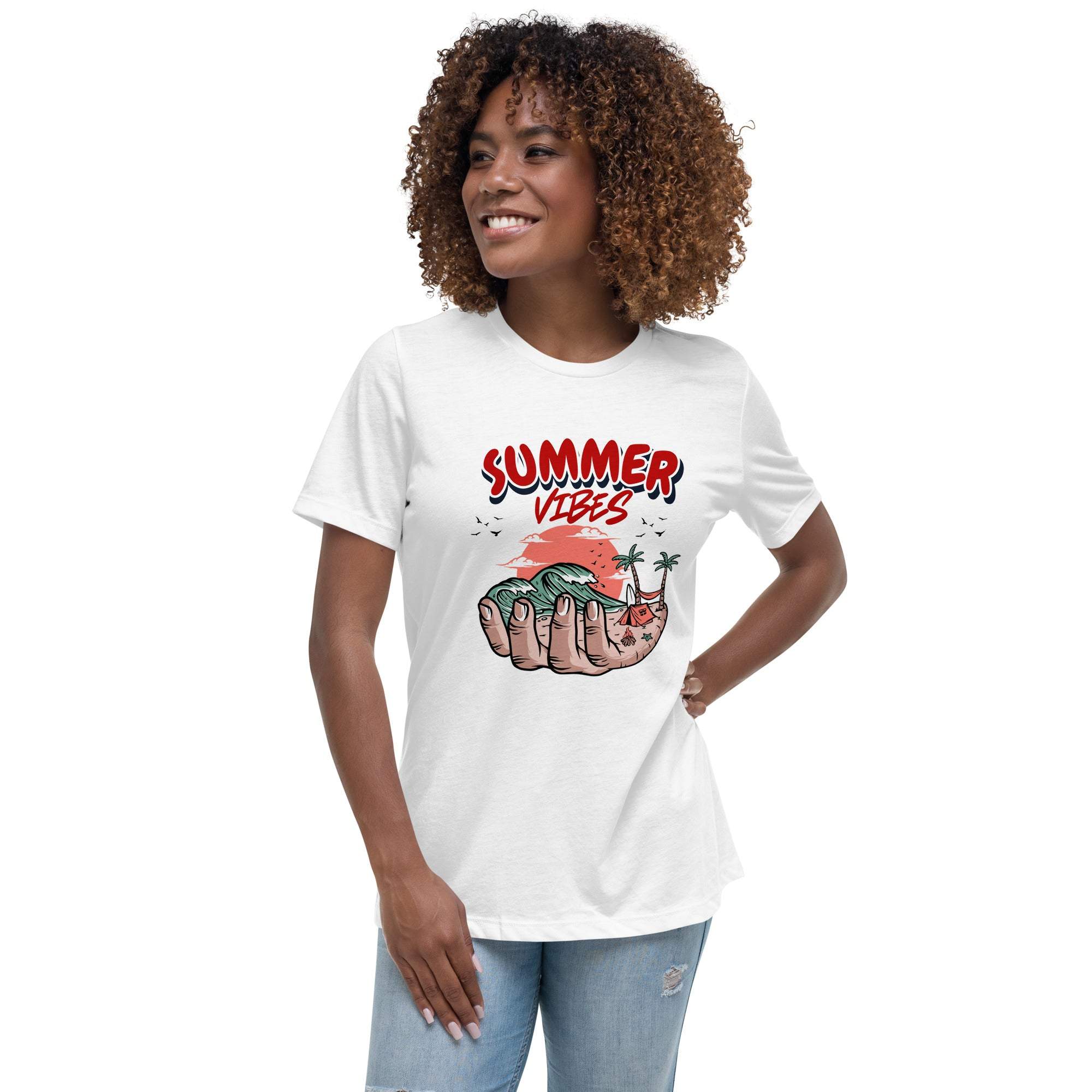 Woman wearing white Summer Vibes T-Shirt with retro beach graphic held in a hand, styled with casual jeans.