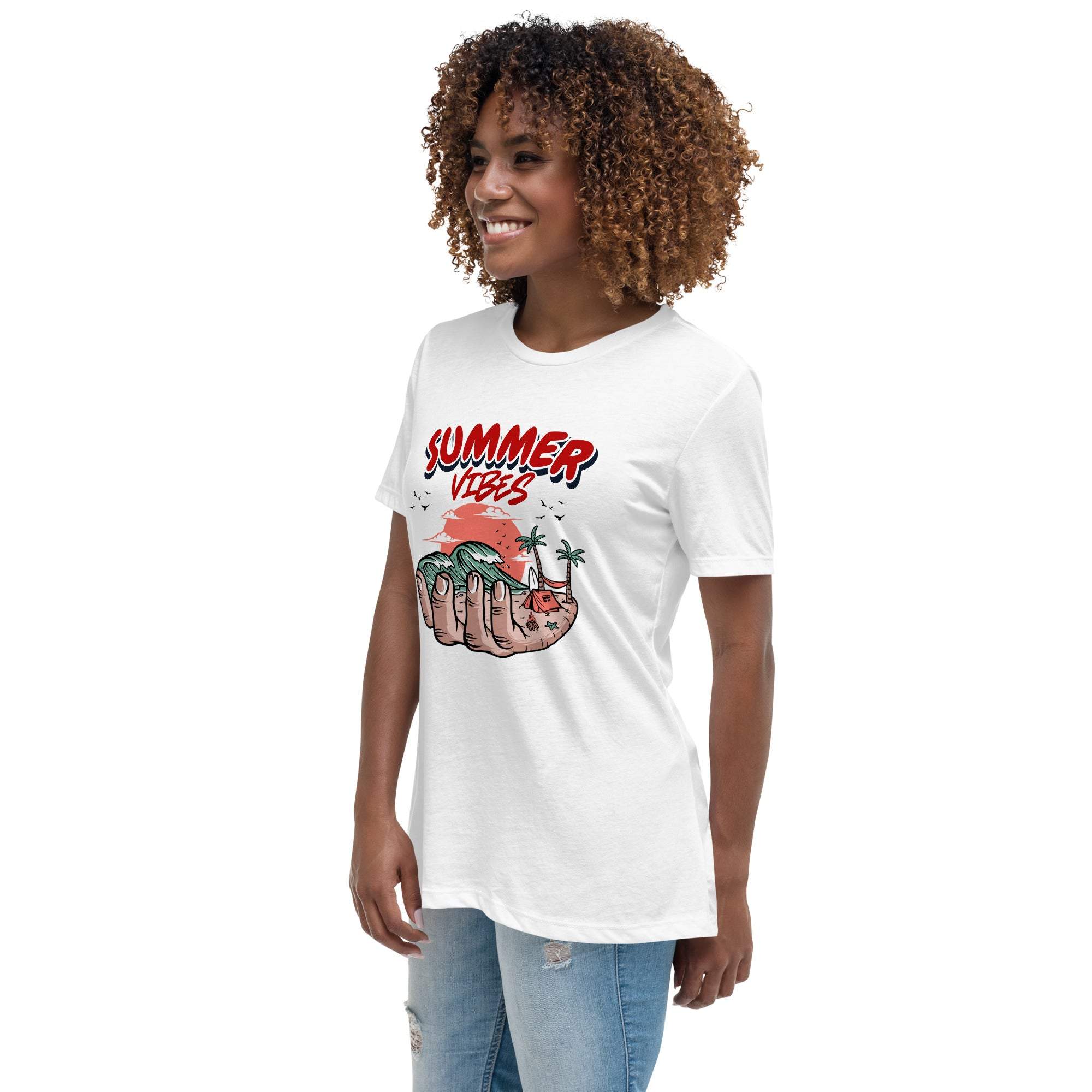 Woman wearing white Summer Vibes T-Shirt with retro beach graphic showing hand holding palm tree and sunset design.