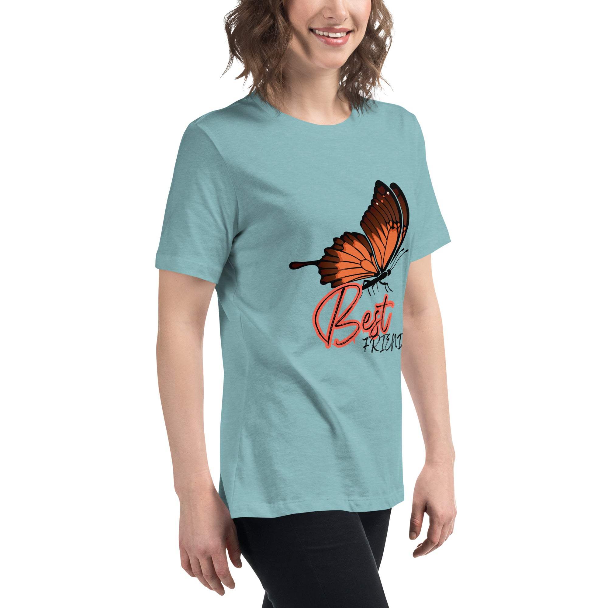 Woman wearing a light blue Best Friend Butterfly T-Shirt with an orange butterfly graphic and "Best Friend" text, styled casually with black pants.