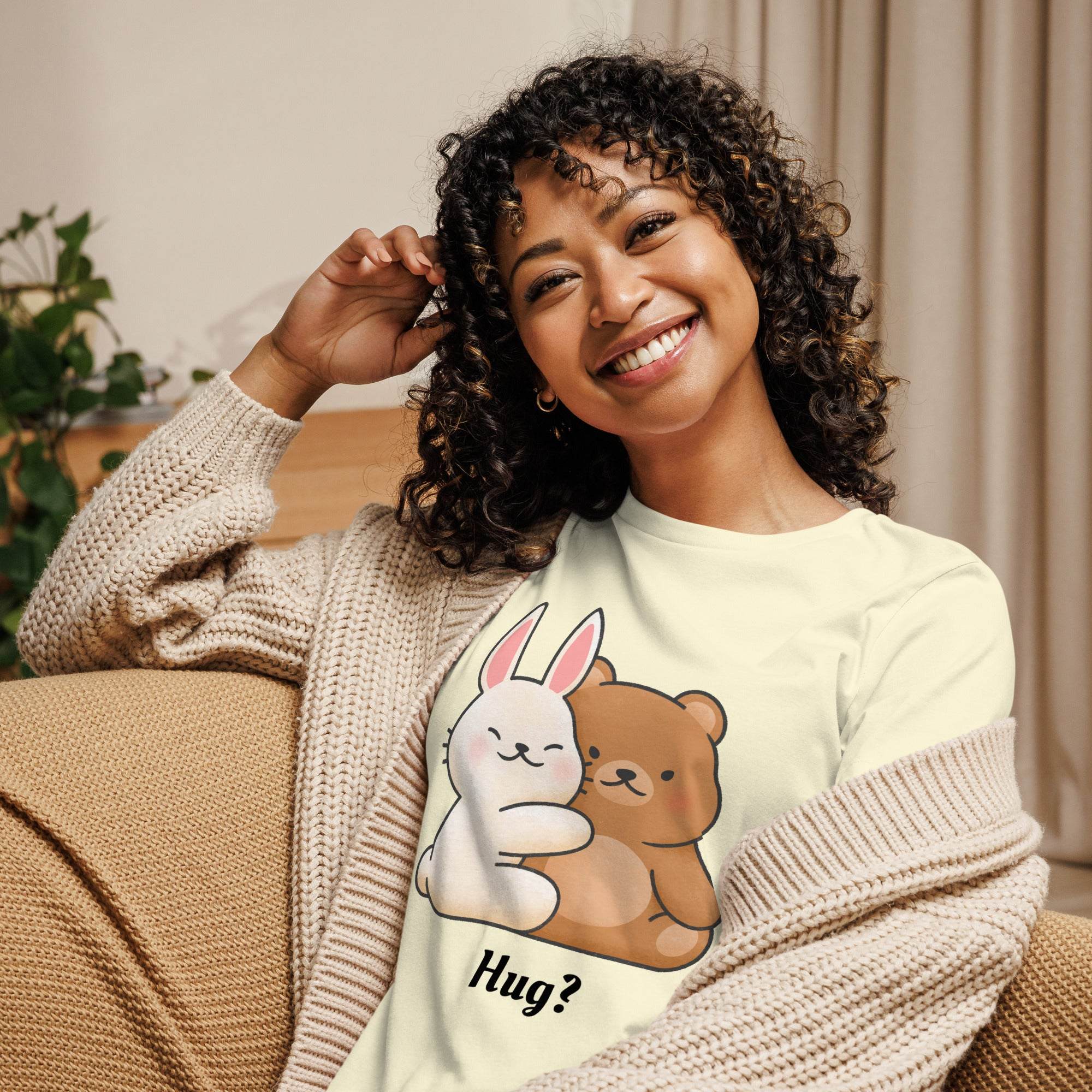 Woman wearing a Cute Bunny and Bear Hug T-Shirt featuring a pastel-colored cartoon bunny and bear hugging with the word "Hug?" printed below.