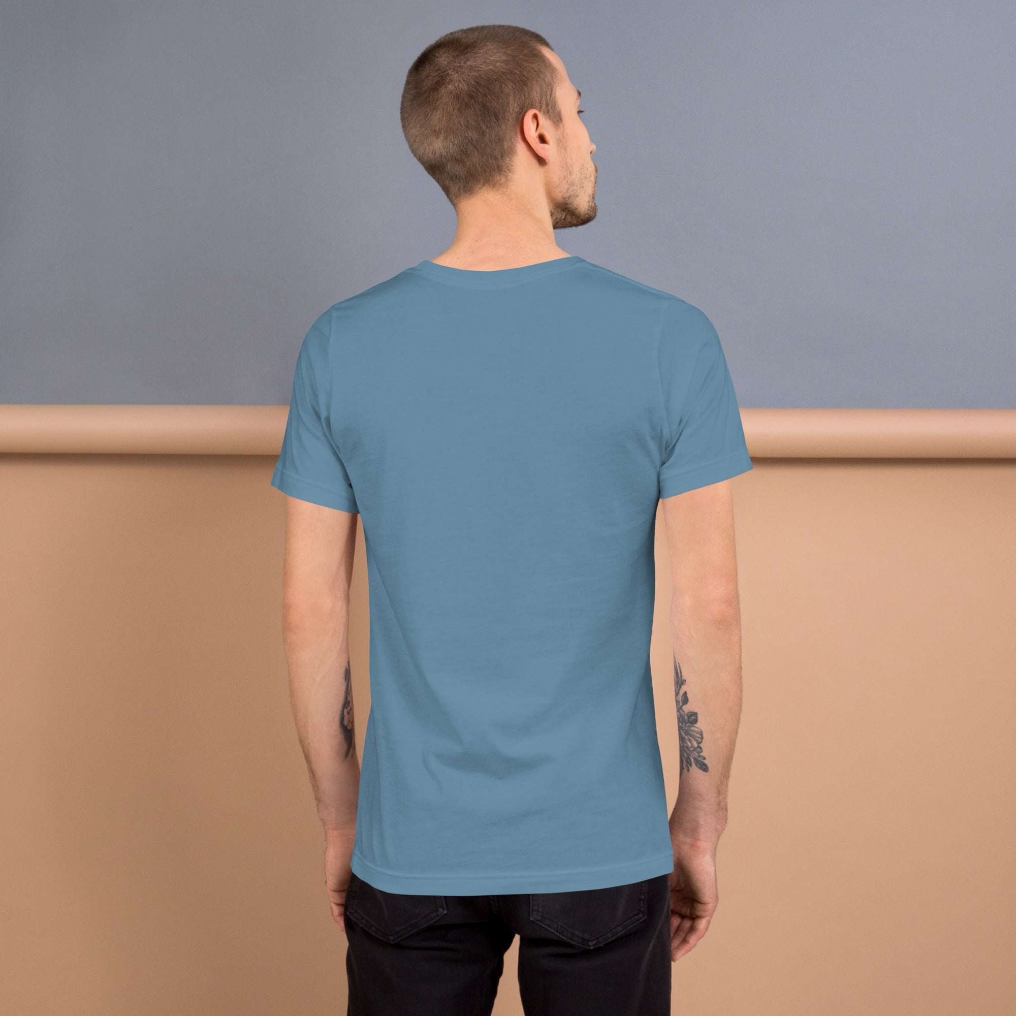 Man wearing a blue Good Vibes T-Shirt viewed from the back against a neutral background