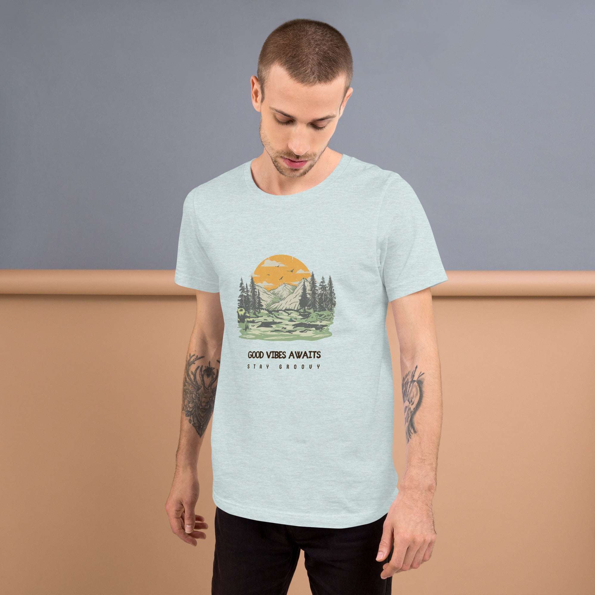 Man wearing Good Vibes Awaits soft lightweight cotton t-shirt with nature graphic and text design