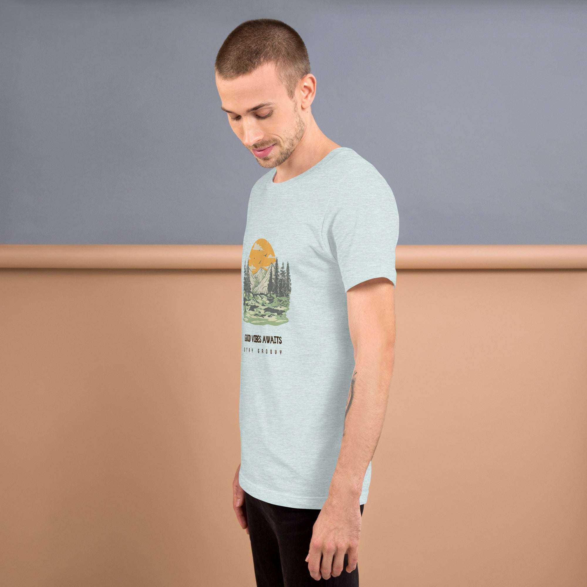 Man wearing light blue Good Vibes Awaits T-Shirt with nature graphic and casual fit