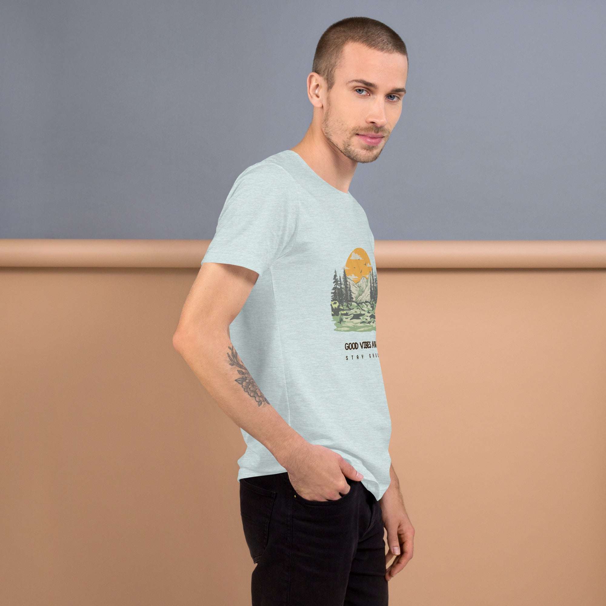 Man wearing light gray Good Vibes T-Shirt with nature graphic on front