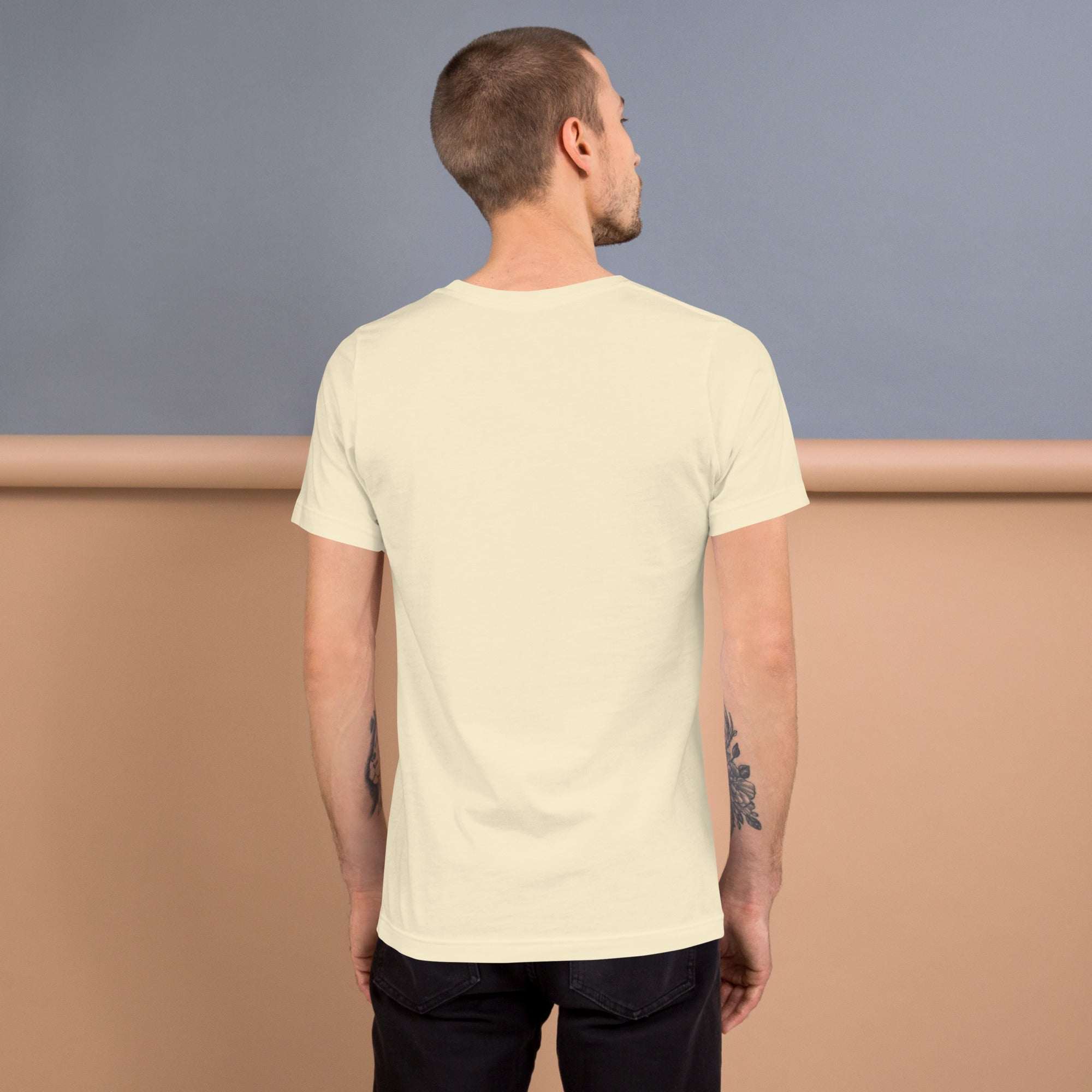 Back view of man wearing lightweight soft Good Vibes T-Shirt in cream color