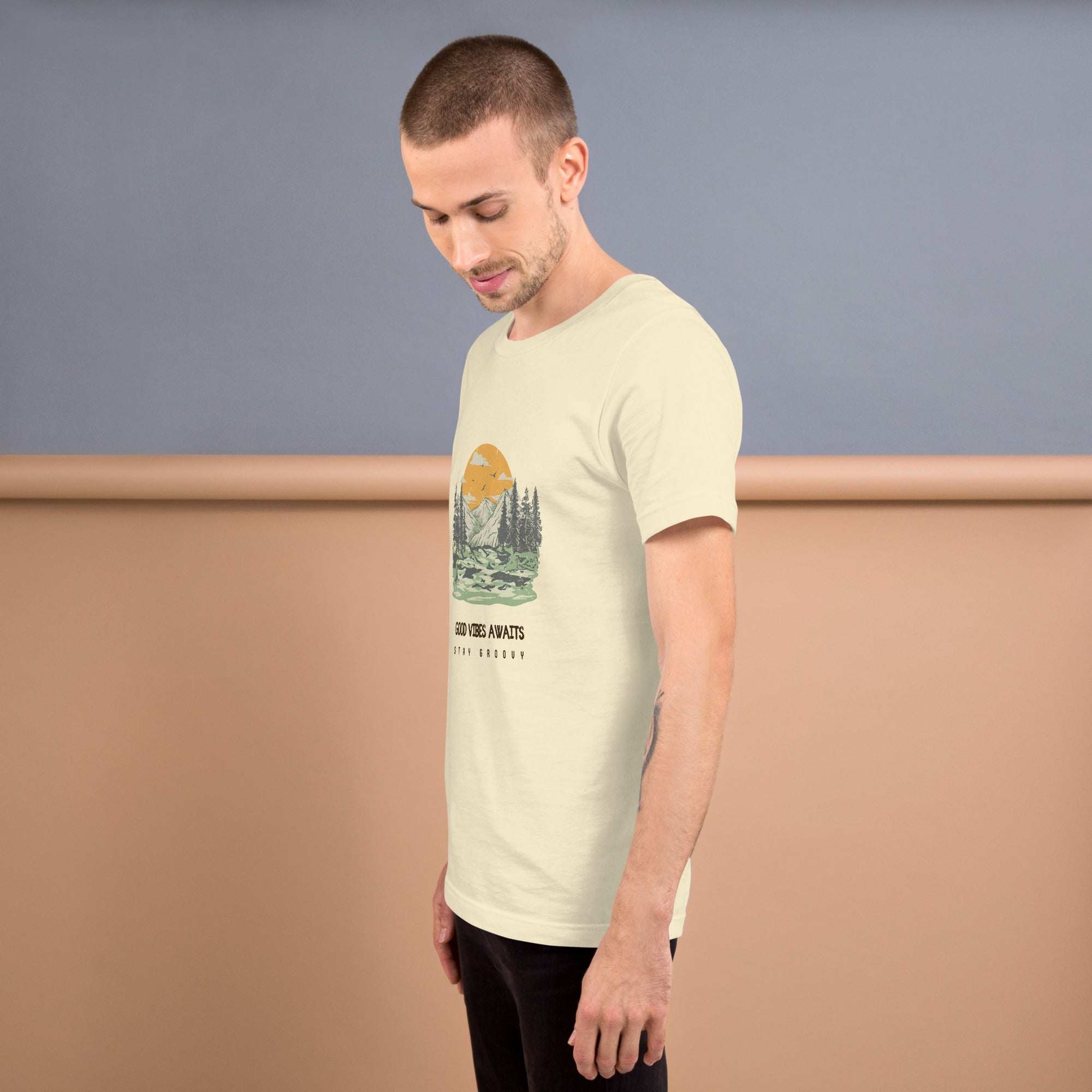 Man wearing a beige Good Vibes Awaits T-Shirt with nature graphic, soft lightweight cotton, comfortable fit