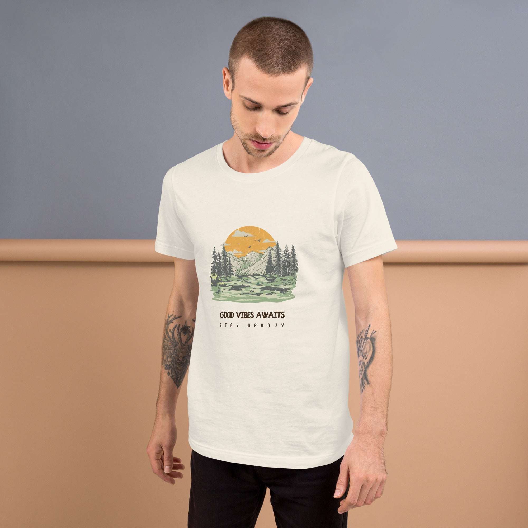 Man wearing white Good Vibes Awaits T-Shirt with nature graphic and text, soft lightweight fabric