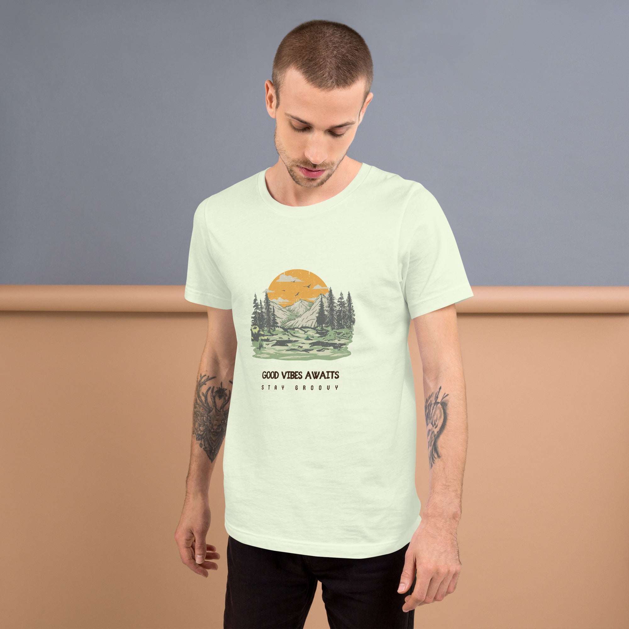 man wearing Good Vibes Awaits T-shirt with mountain and forest print