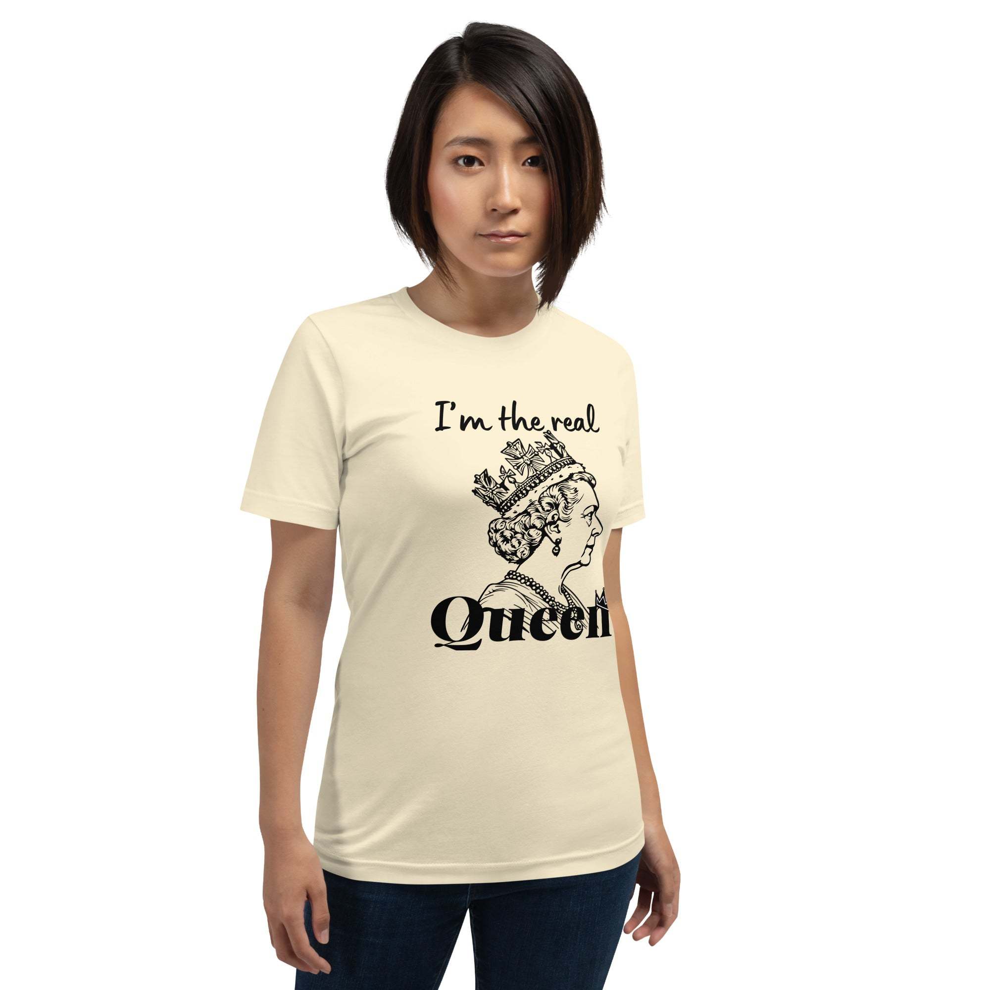 Woman wearing cream Real Queen T-Shirt with black crown graphic and statement text.