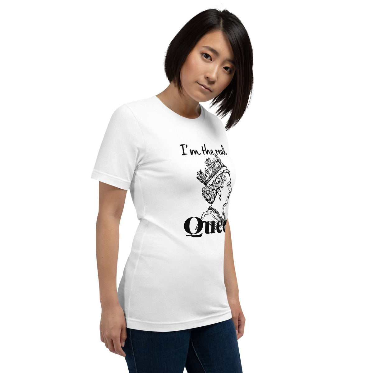 Woman wearing white Real Queen T-Shirt with crown graphic and statement text, styled casually with jeans.