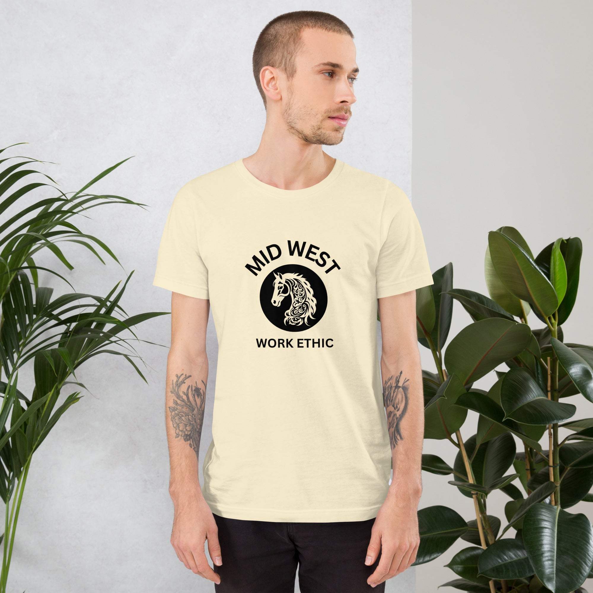 Man wearing Midwest T-Shirt with horse graphic and work ethic text in casual indoor setting