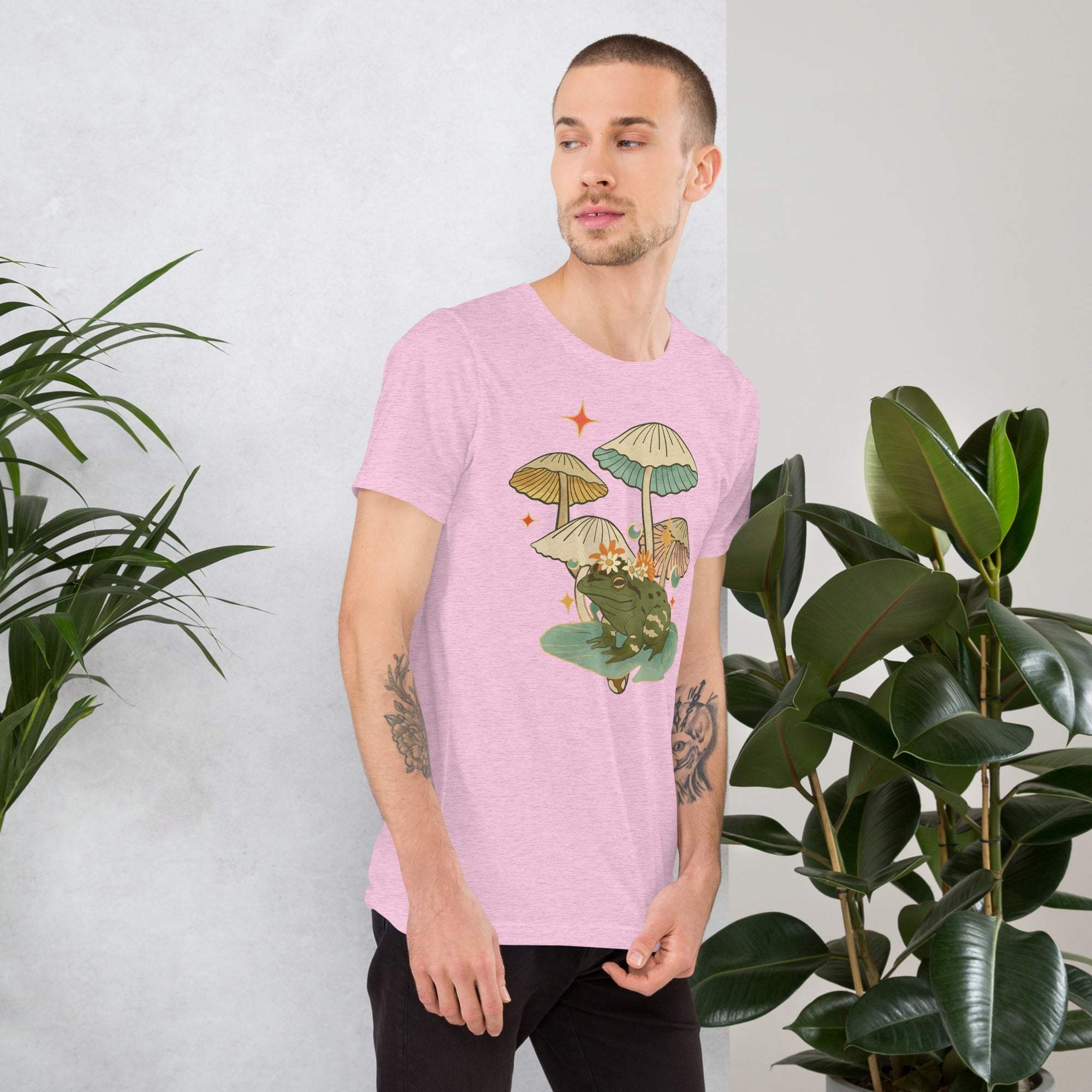 Man wearing vintage aesthetic frog and mushroom T-shirt with nature-inspired graphic design
