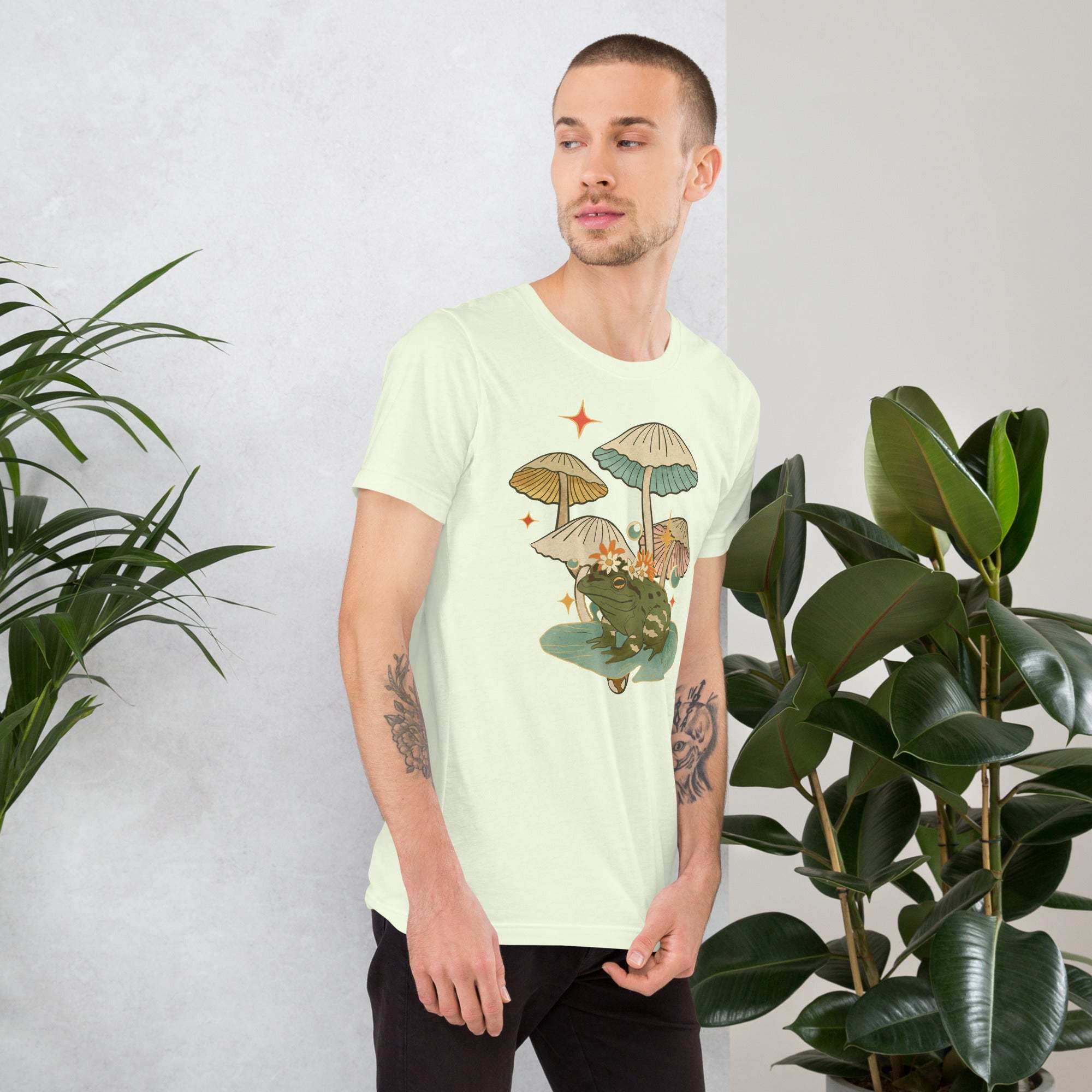 Man wearing vintage aesthetic frog and mushroom t-shirt with nature-inspired design