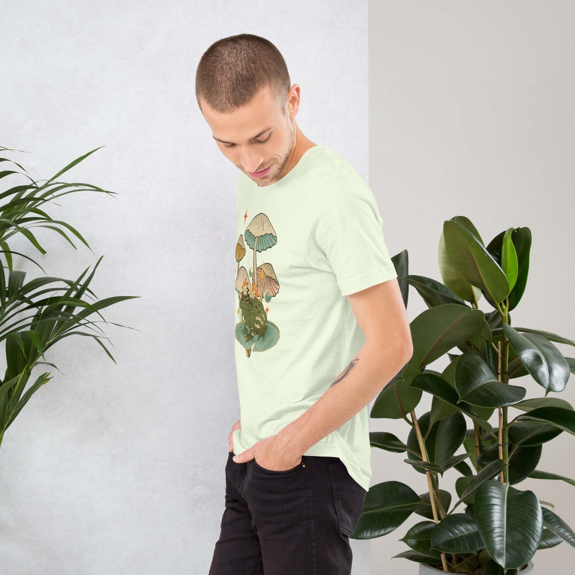 Man wearing vintage aesthetic Frog and Mushroom T-Shirt with cottagecore toadstool graphic in soft cotton unisex fit