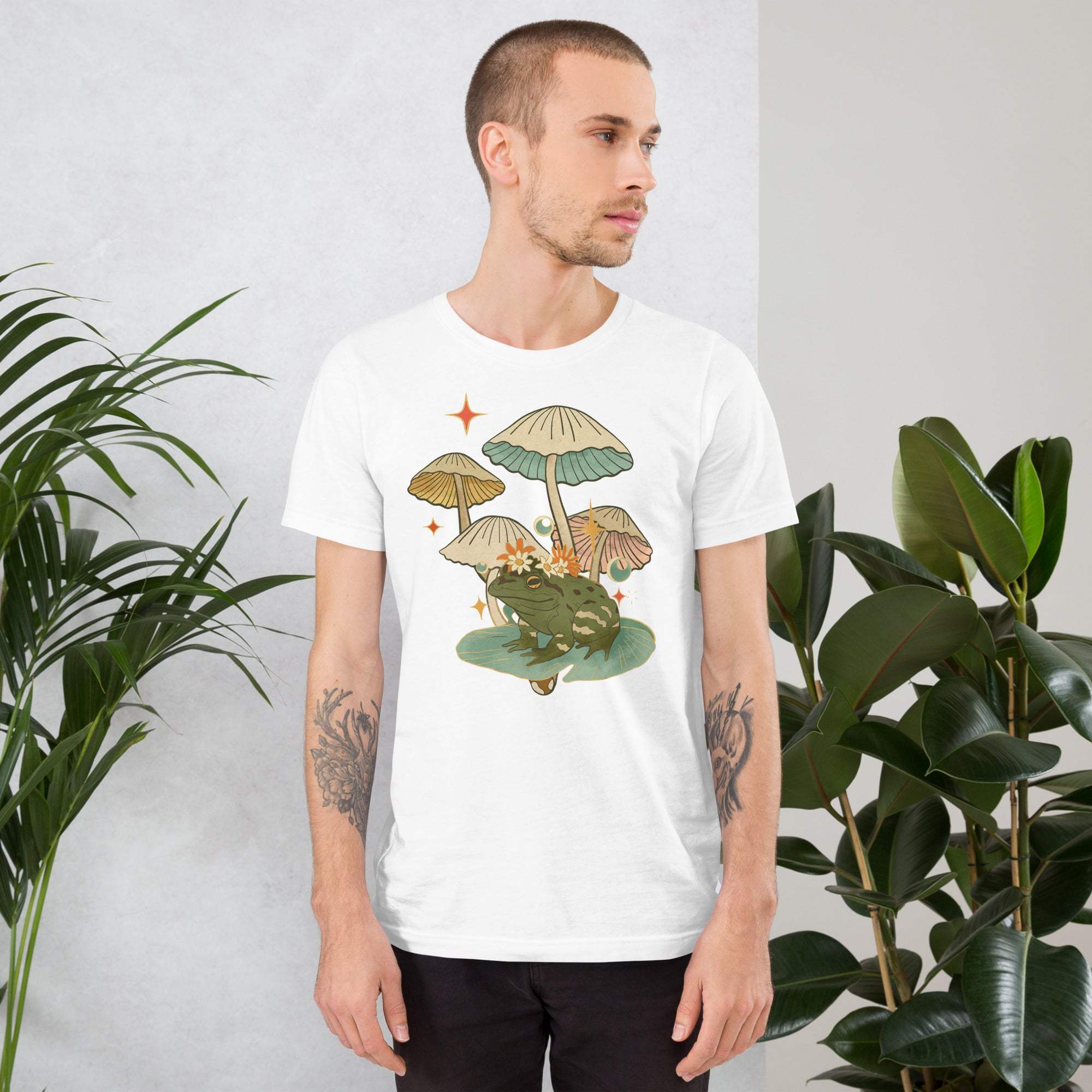 Man wearing white frog and mushroom t-shirt with vintage cottagecore design