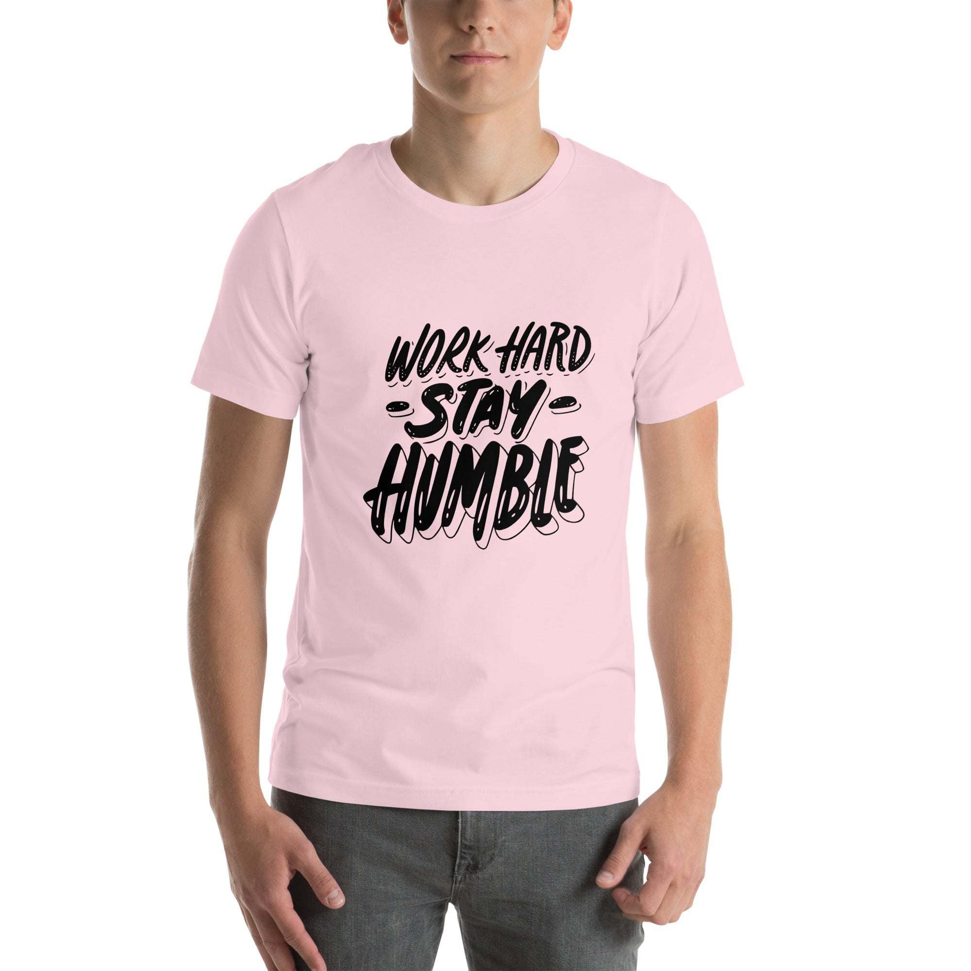 Man wearing light pink Work Hard Stay Humble T-Shirt with black motivational text design