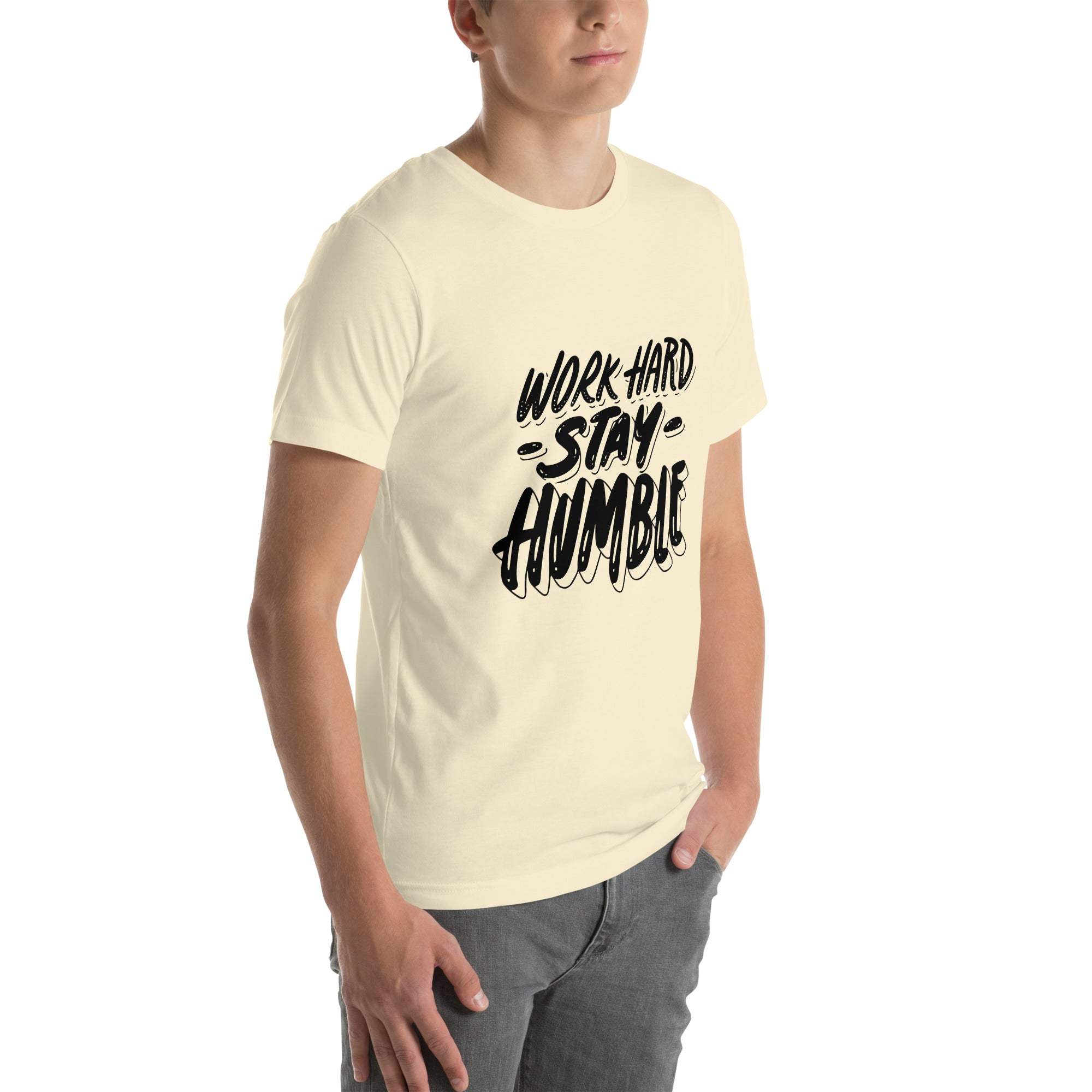 Man wearing cream Work Hard Stay Humble T-Shirt with motivational black graphic text