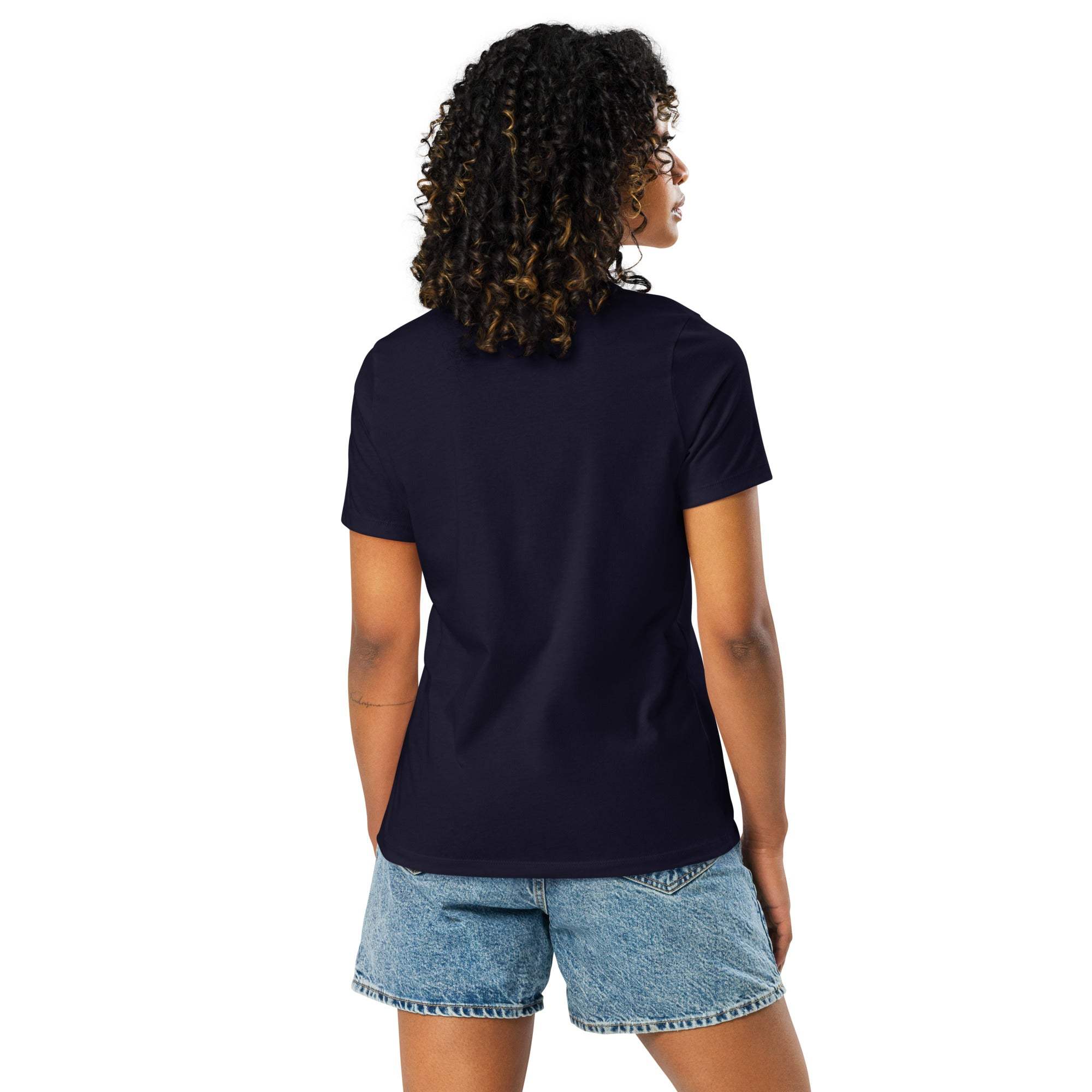 Woman wearing navy Adventure Awaits T-Shirt back view with denim shorts
