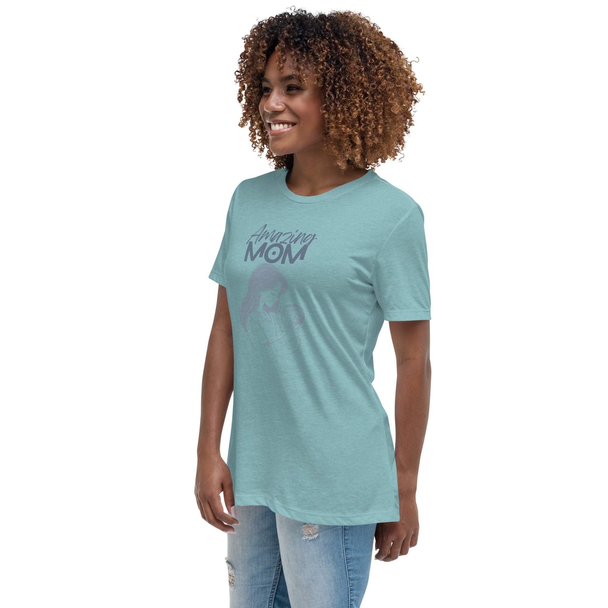 Woman wearing a light blue Amazing Mom T-Shirt with a casual fit and jeans, smiling and standing against a white background