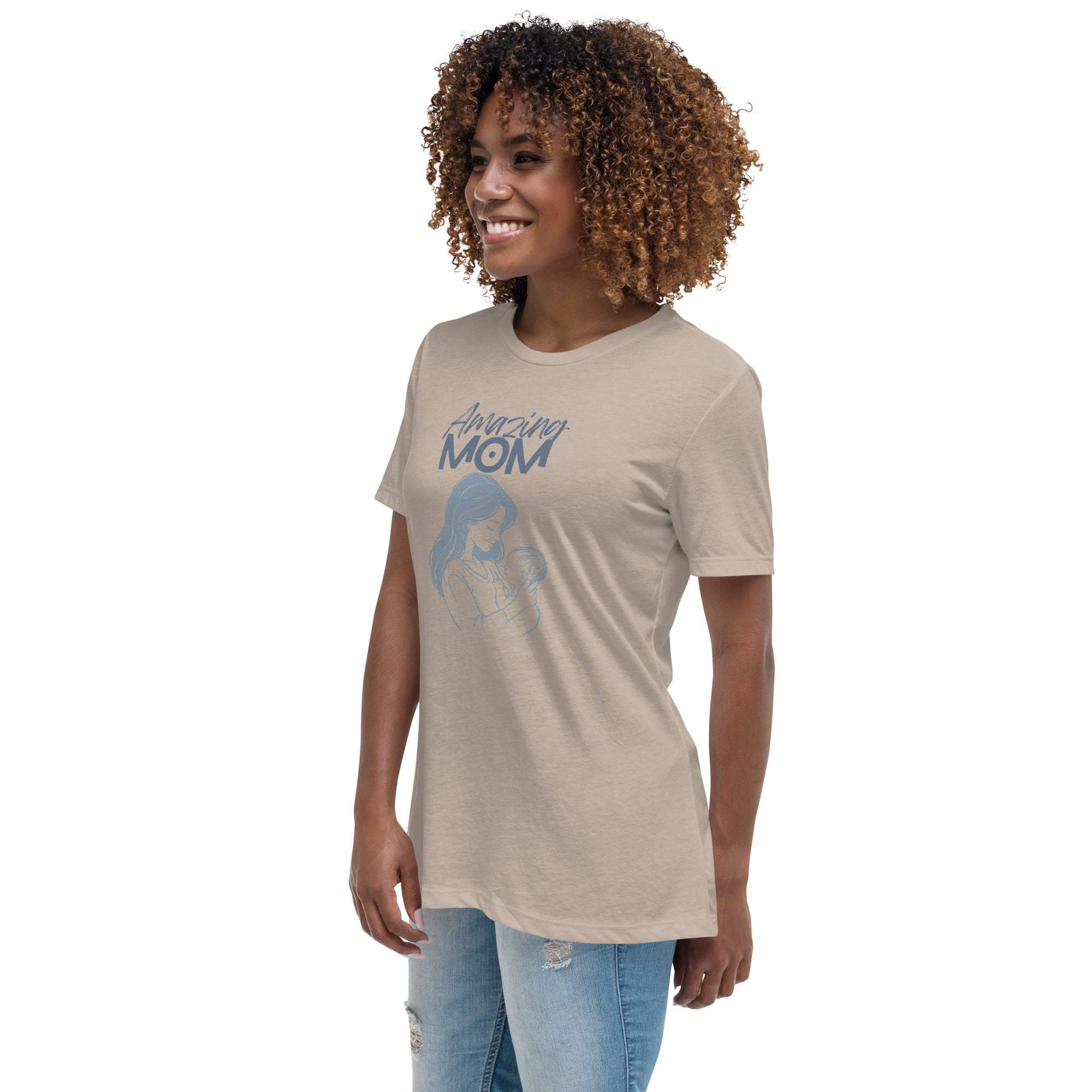 Woman wearing beige Amazing Mom T-Shirt with graphic design, paired with ripped jeans.